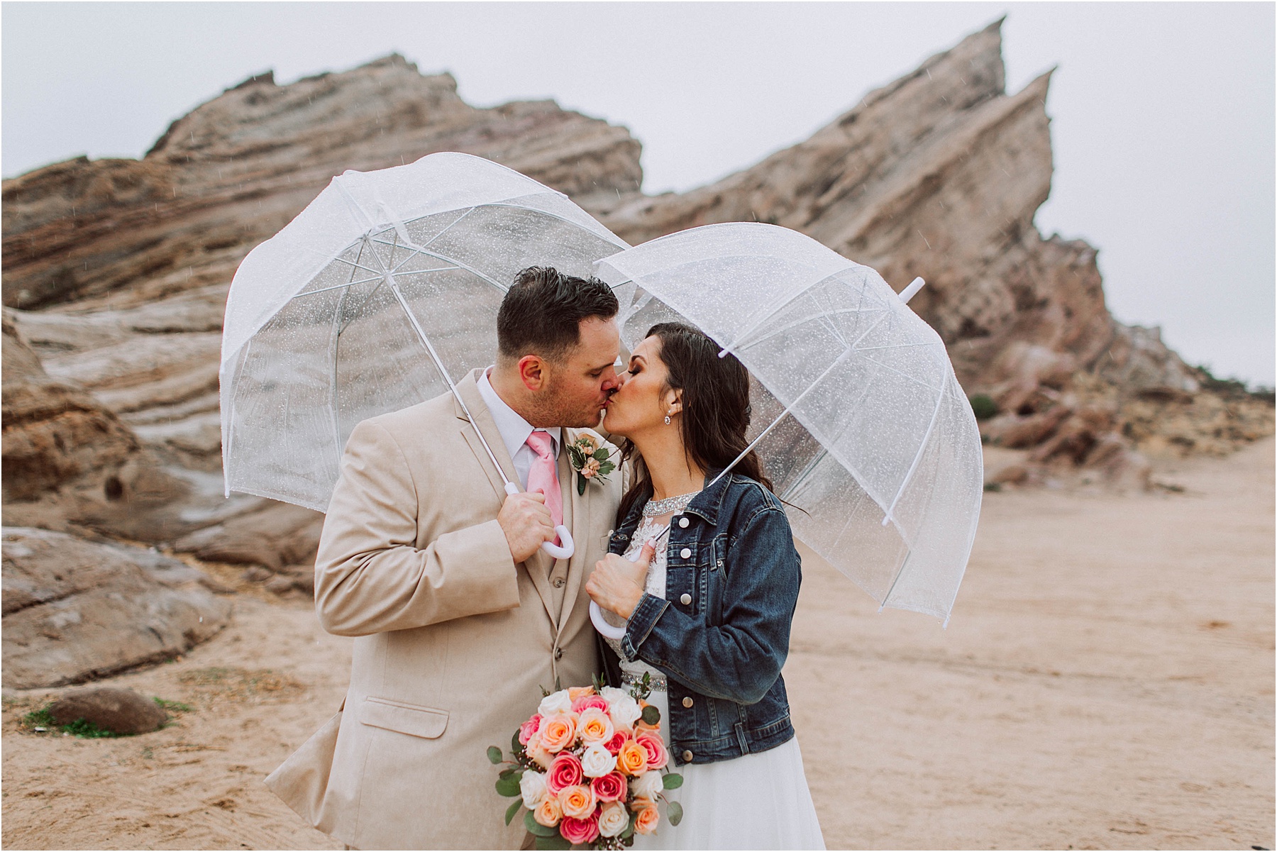 Vasquez Rocks Intimate Wedding & Elopement Photography - Bride & Groom Portraits in the rain with umbrellas