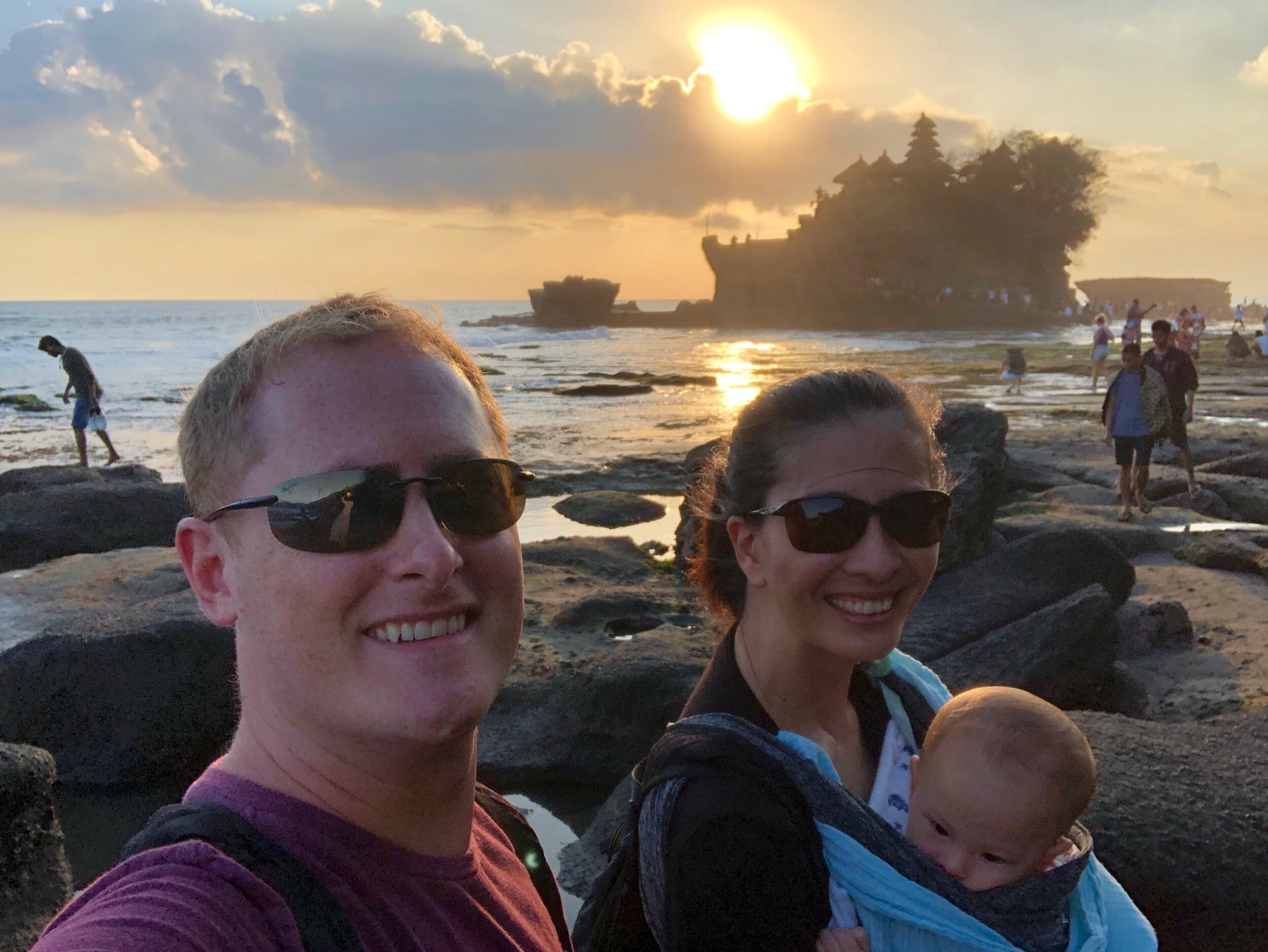 Family Travelers in front of Tannah Lot Temple in Bali, Indonesia