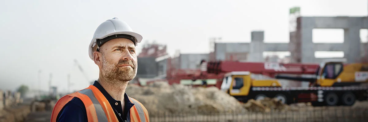 Business owner with contractors behind him.image