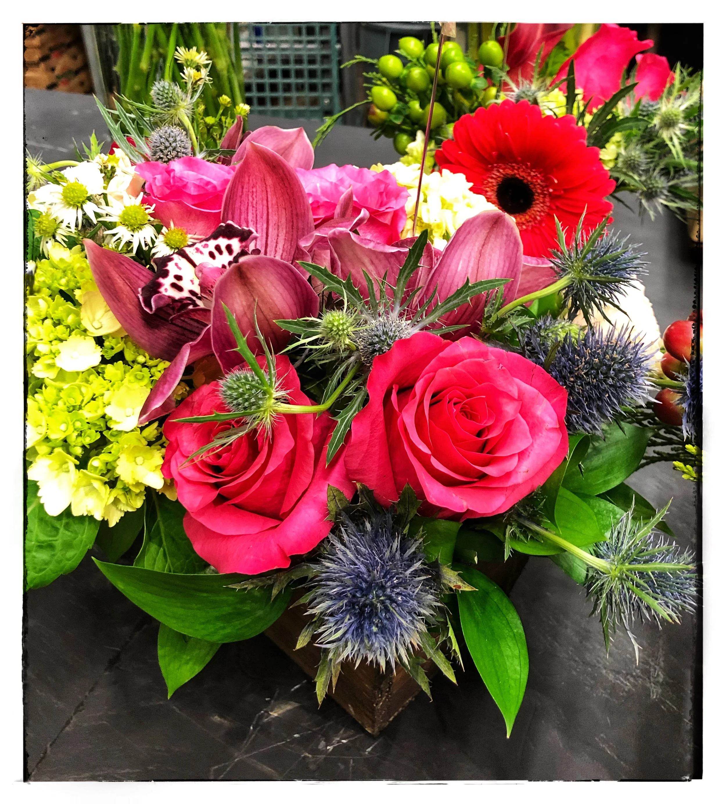 Holiday Floral Arrangements include roses, eryngium, hydrangeas and orchids.