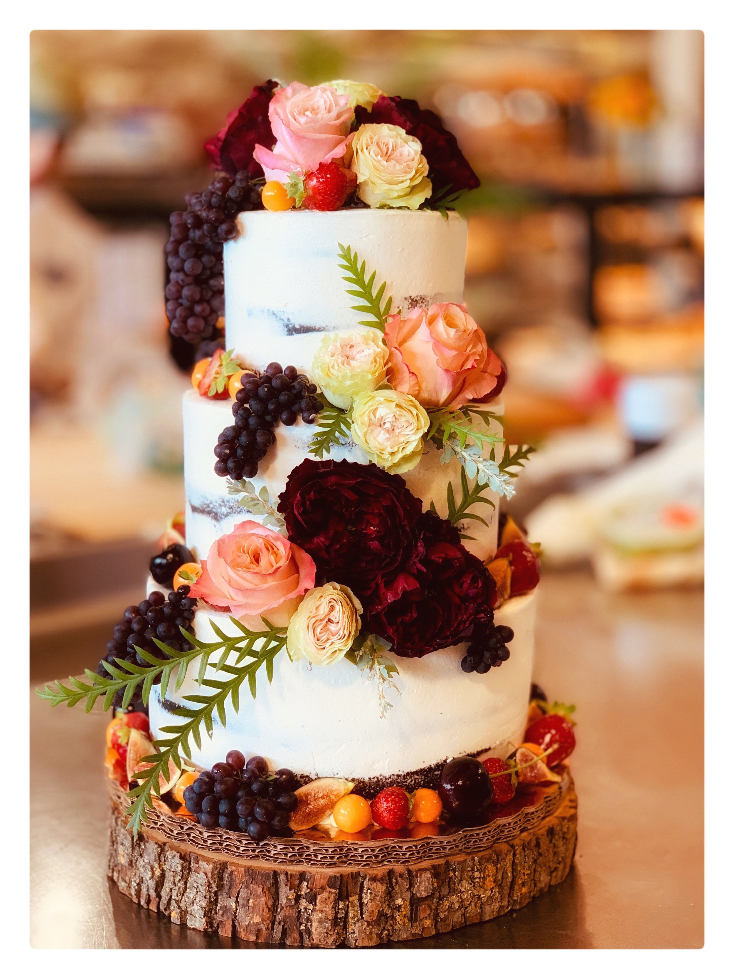 Wedding cake made with fresh fruit and flowers.