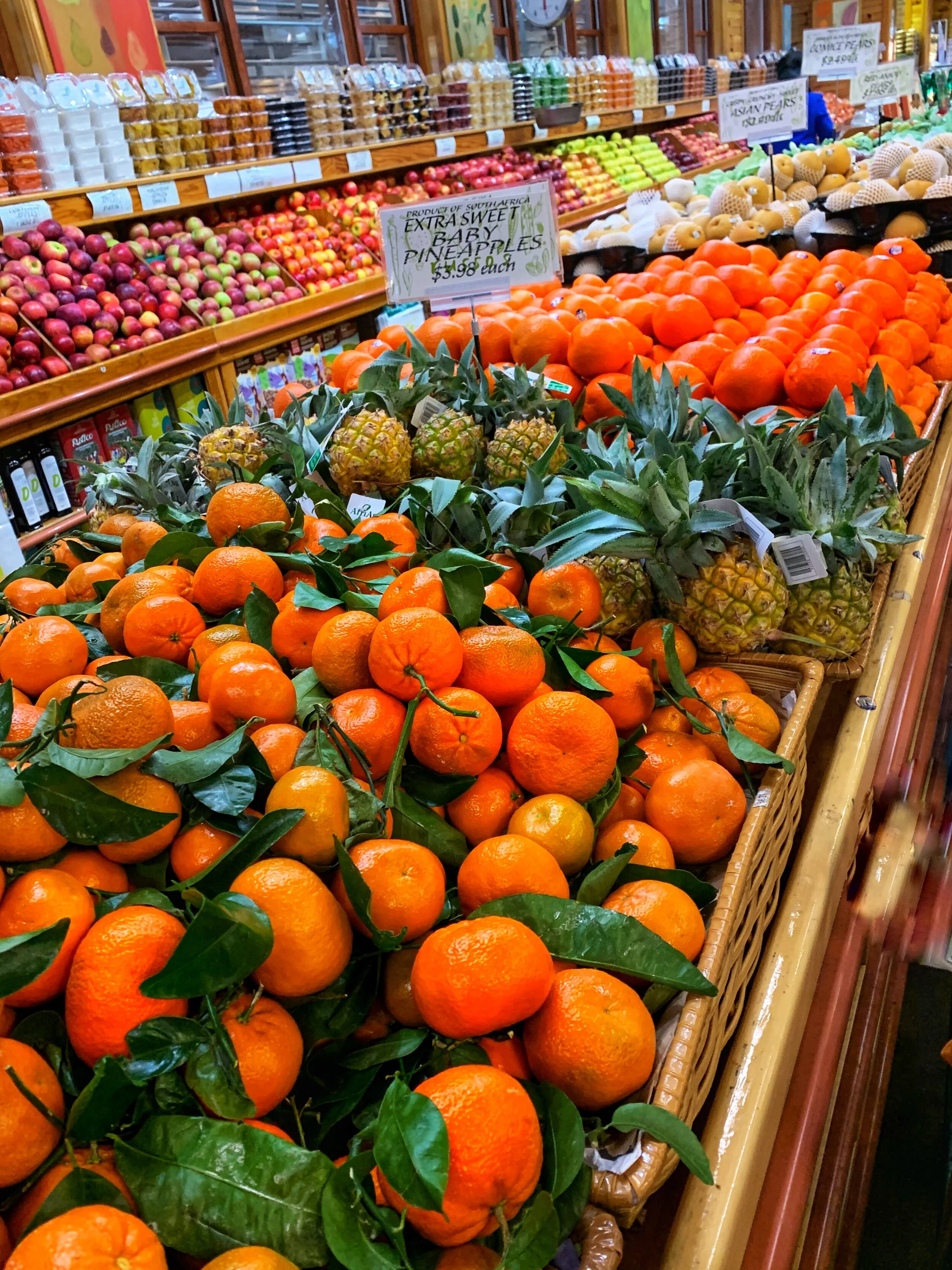 Stem and leaf mandarins, baby pineapples and apples at our store. Thank you Tony Russo for this photo!