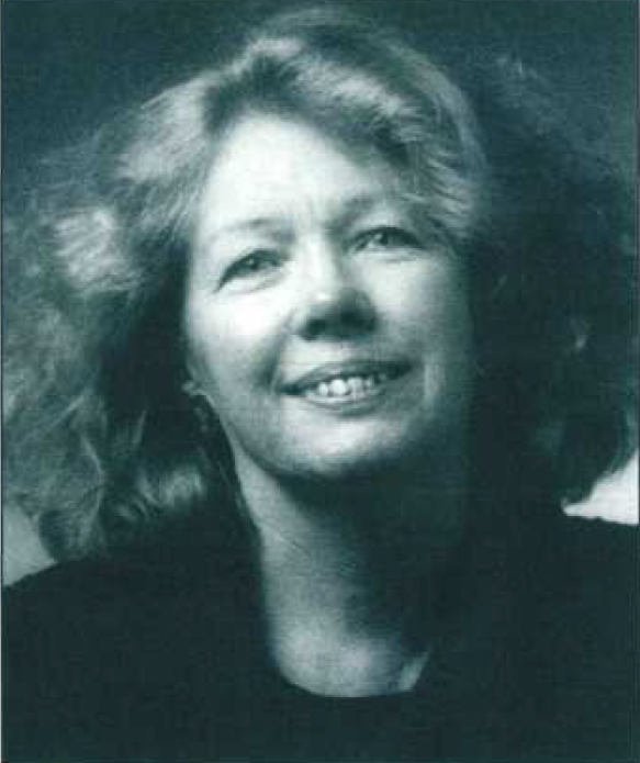 Black-and-white portrait of a woman with wavy hair, smiling and looking slightly upwards.