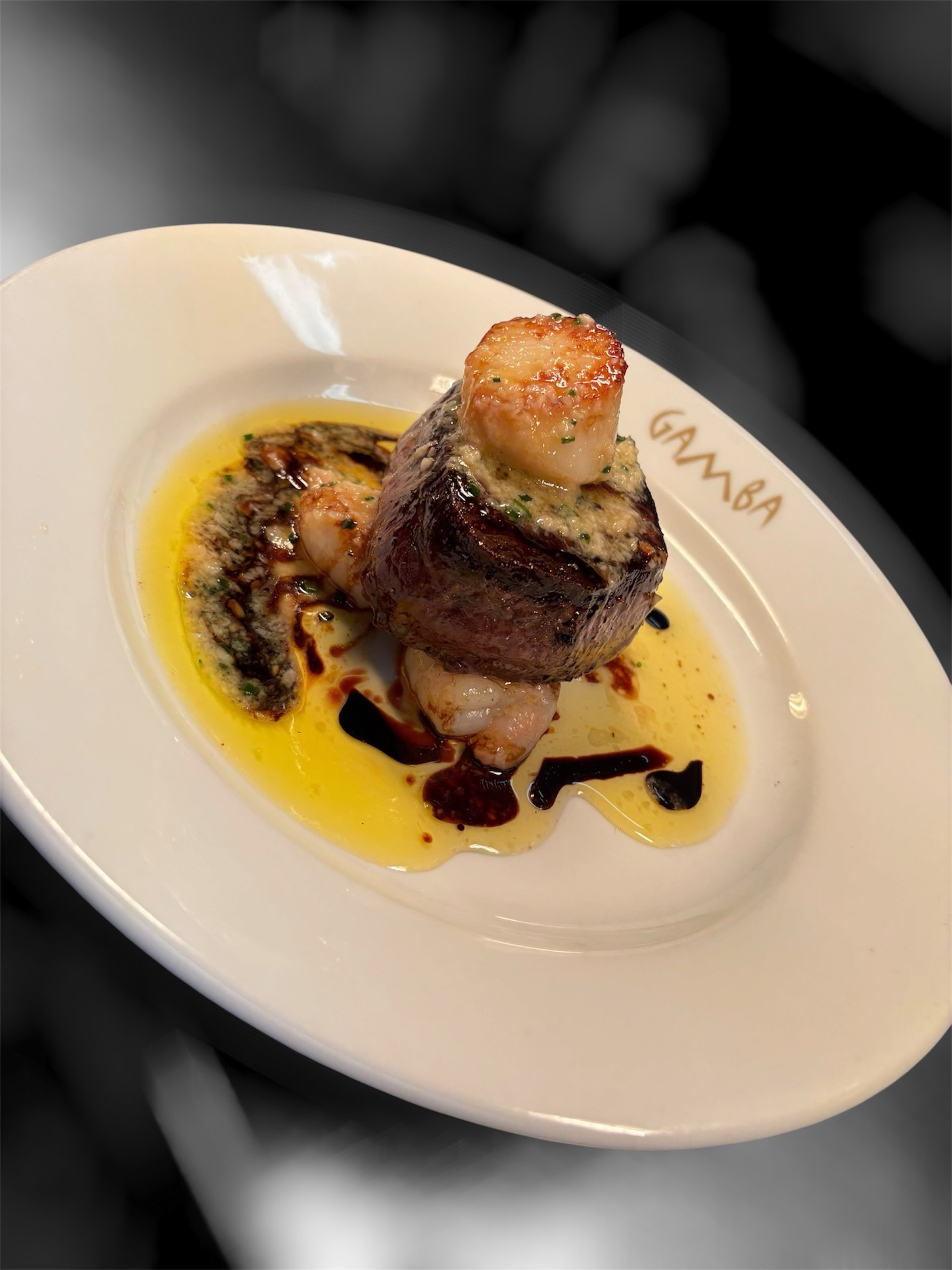 Surf &amp; Turf Wednesdays. Two Scotch fillet steaks, with jumbo king prawns, scallop, garlic butter and sweet soy. Gamba&rsquo;s chips. Includes a bottle of wine, choose from red or white. All for &pound;99 for two persons. 

Available all day Wedne