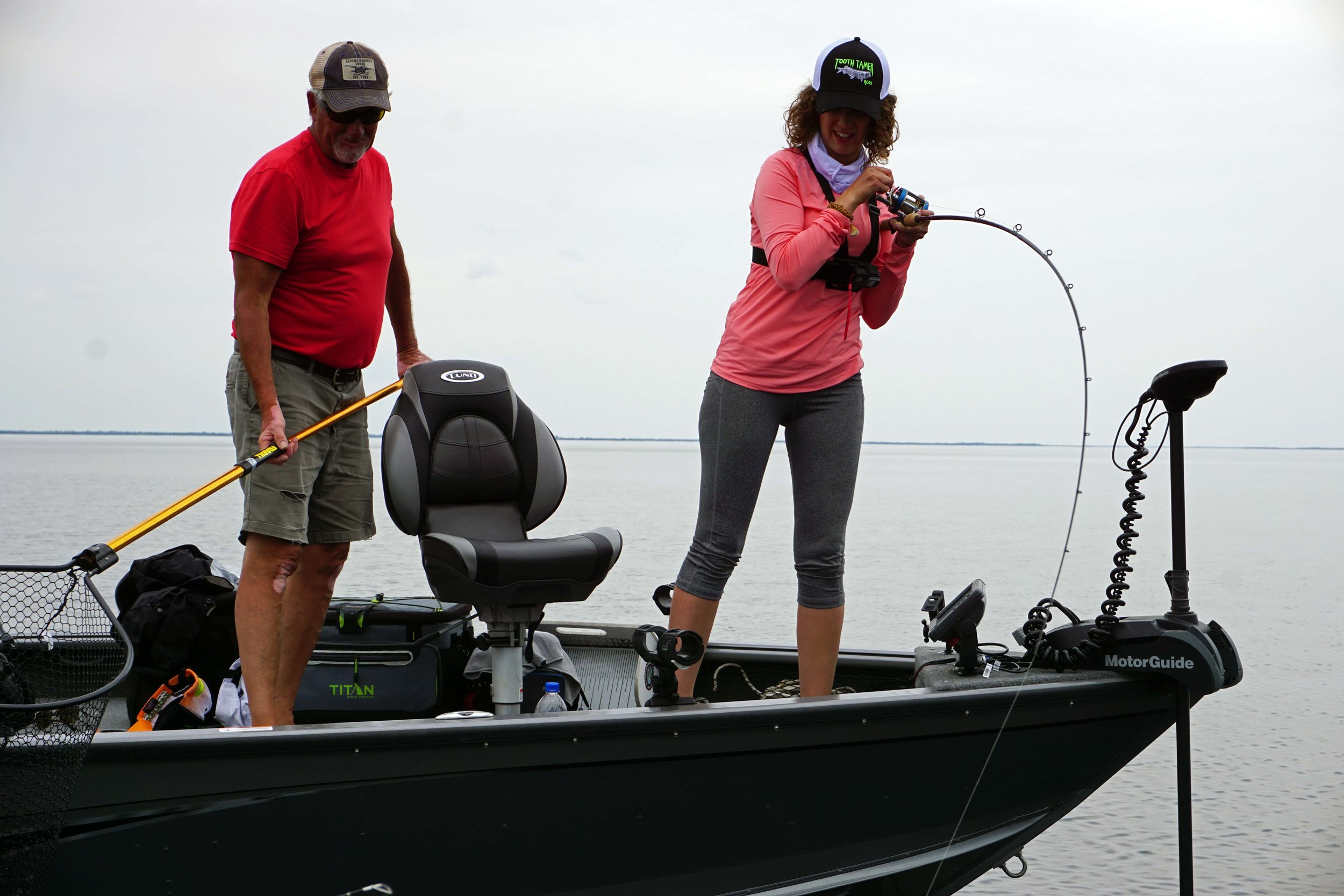 Ana on Ice pulling up a lake trout while vertical jigging in Bakers Narrows.