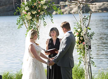 A wedding ceremony at the water's edge, Sylvan Lake Lodge in Custer State Park