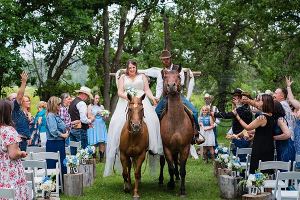  COWBOY LOVE – Riding back down the aisle under a shower of flower buds  photo ©    Taylor Hulett Photography   
