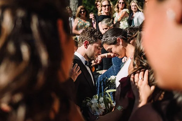  Caption: LAYING ON OF HANDS – Guests bestow blessings through their hands  photo ©    Nina Lily Photography   