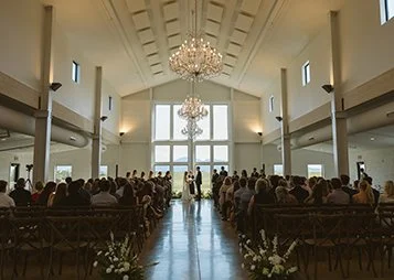 Chandeliers and huge windows make for a gorgeous indoor wedding ceremony space