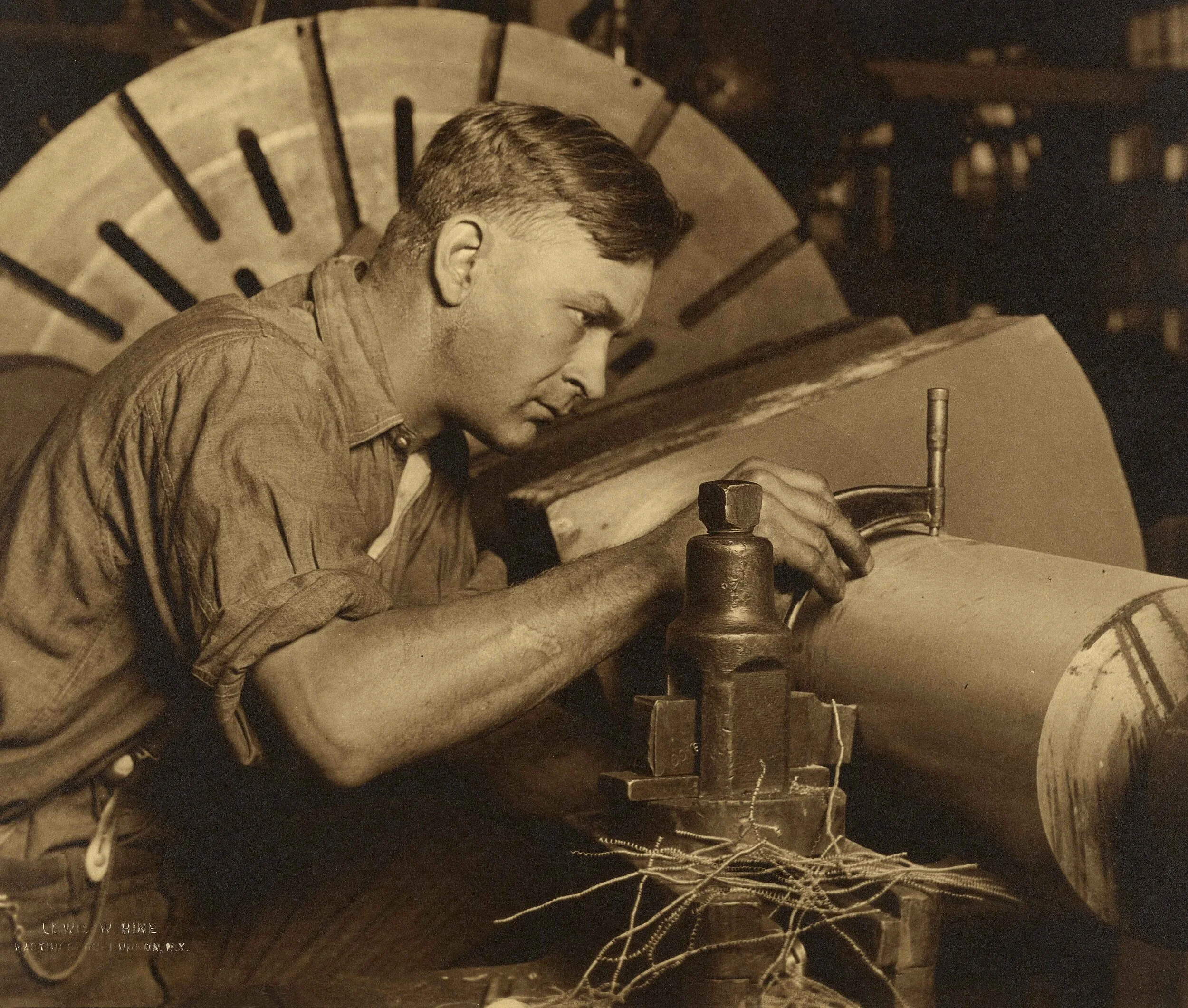 Lewis Hine, Man with Micrometer measuring a shaft to a thousandth of an inch, c1920s