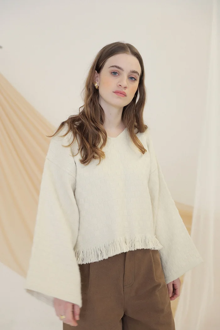 kordal alpaca box weave bell sleeve fringe sweater cream sustainable fashion product photography