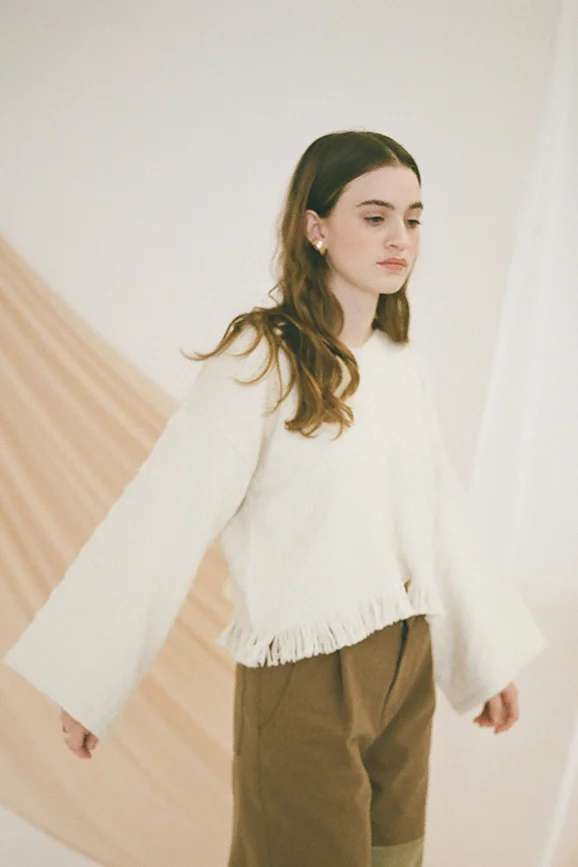 kordal alpaca box weave bell sleeve fringe sweater cream sustainable fashion product photography