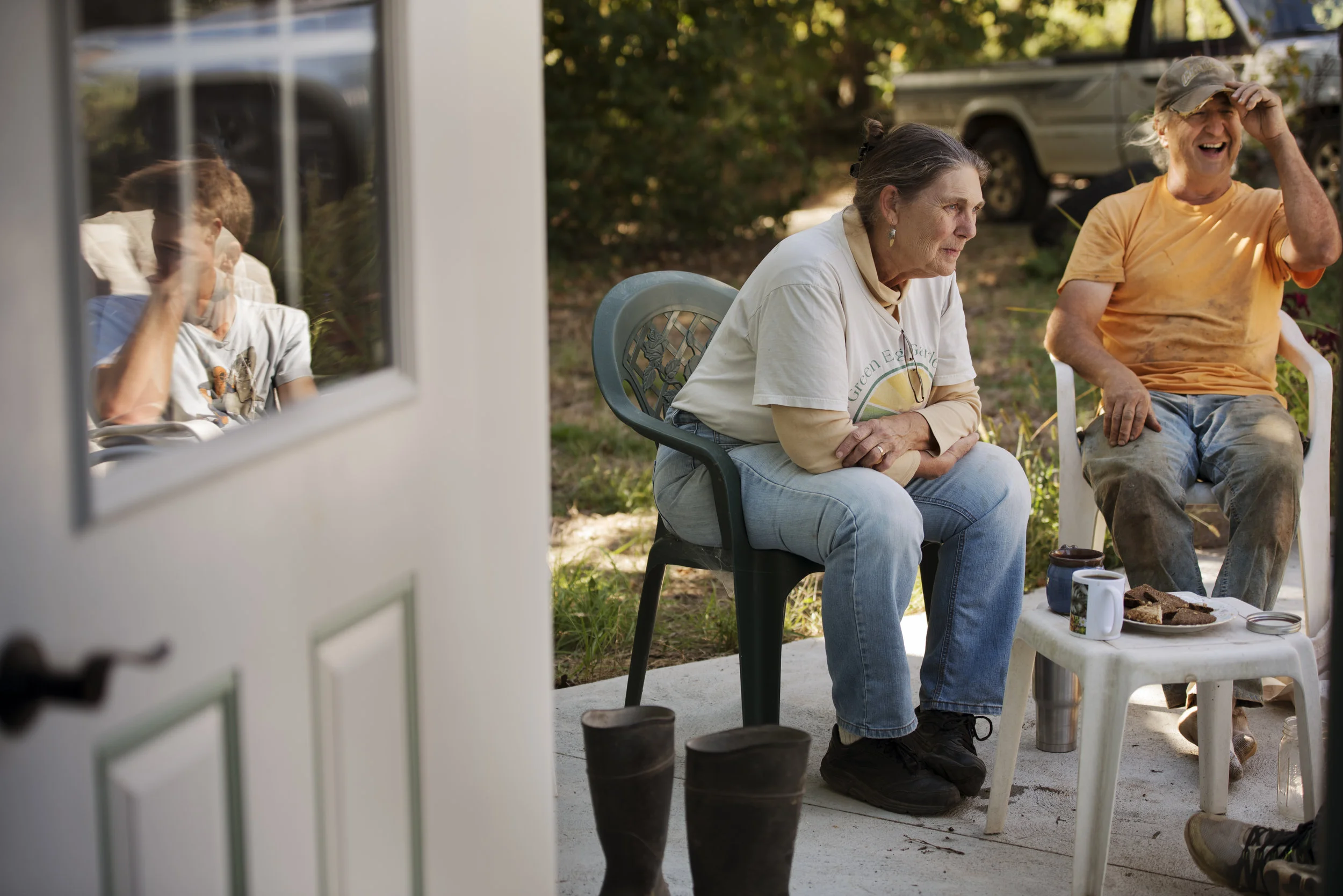 (Left to right) Becky and Kip Rondy have a coffee and cookie break with Wyatt Cooper (pictured in reflection) and Noah Fox (not pictured) after a day's work in the greenhouse.