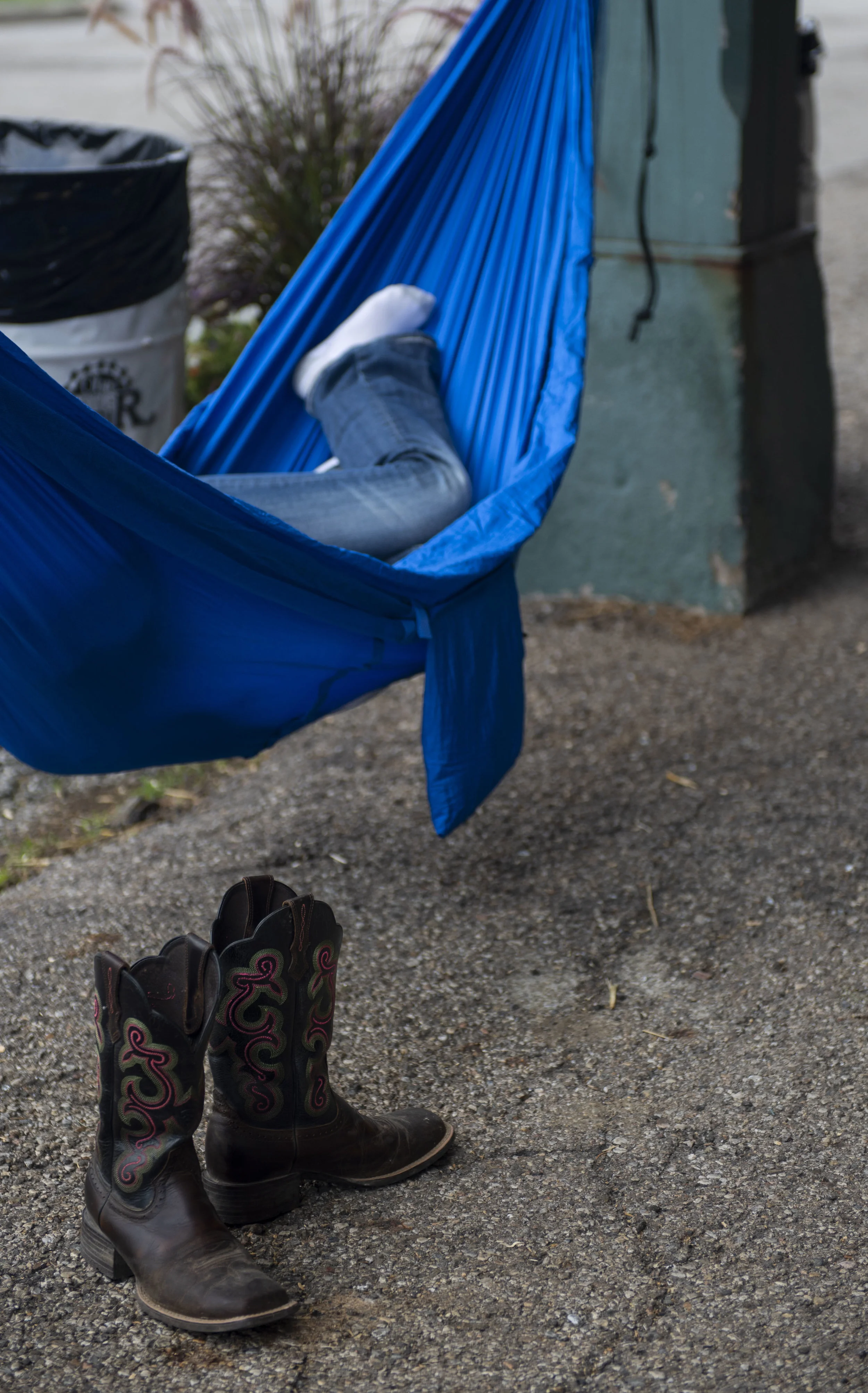  A girl naps in a hammock in the poultry barn. 