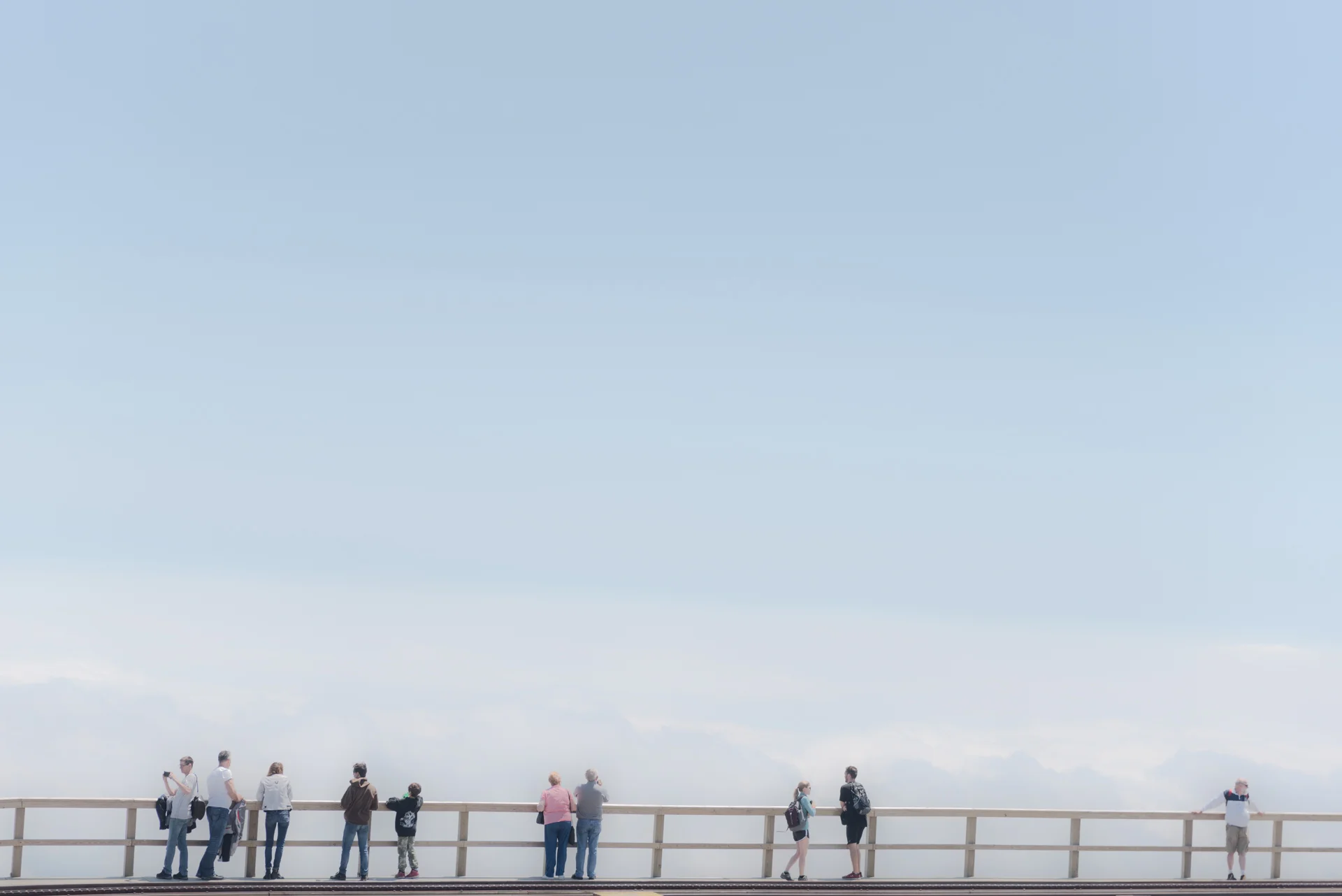 Tourists at Mount Washington, New Hampshire look at the view from the top of the mountain. Mount Washington is the most prominent mountain east of the Mississippi River towering at 6,288 ft, and had the second fastest straight line wind of 231 mph.