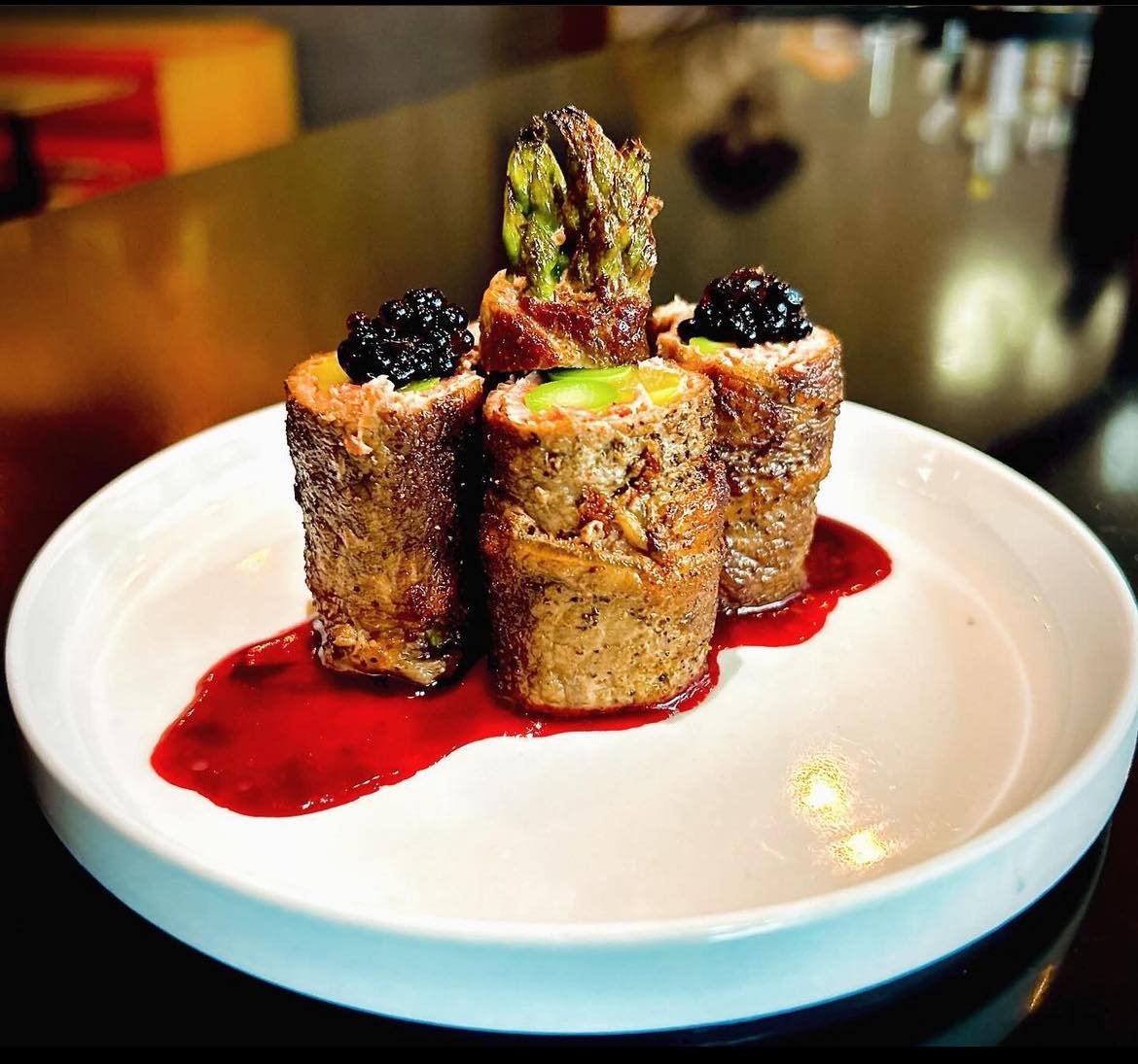 Asparagus Nikumaki - tender beef wrapped asparagus spears in a beet reduction with balsamic pearls. So delicious, and gluten free!

#stadiumdistricttacoma #tacoma #tacomafood #nikumaki