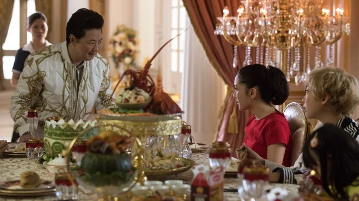 Wye Mun’s speaks to Rachel and Awkwafina, a scene where he switches from a mocking Asian accent to an American one