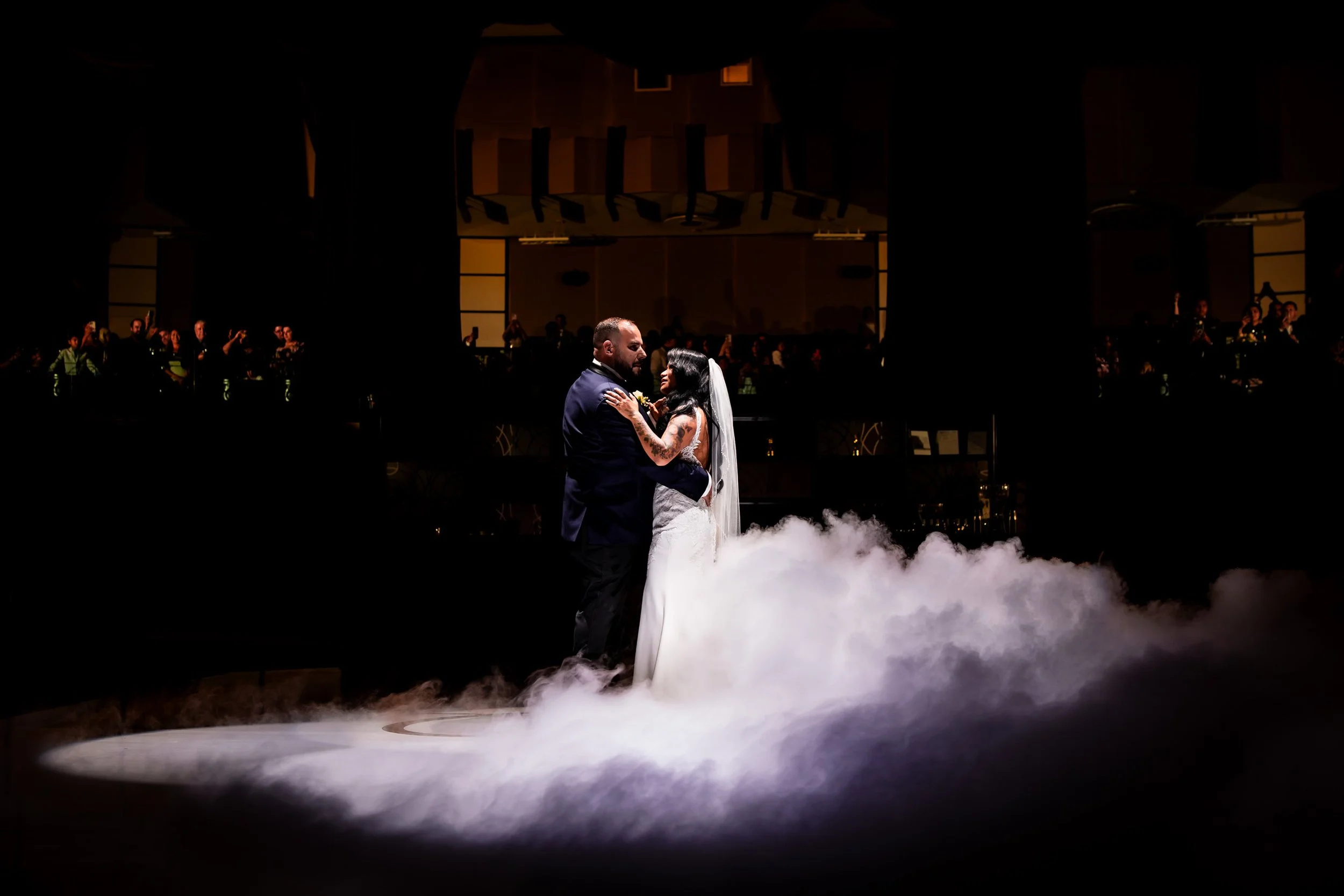 first dance at The Eglinton Grand in Toronto with couple surrounded by low fog and dramatic lighting