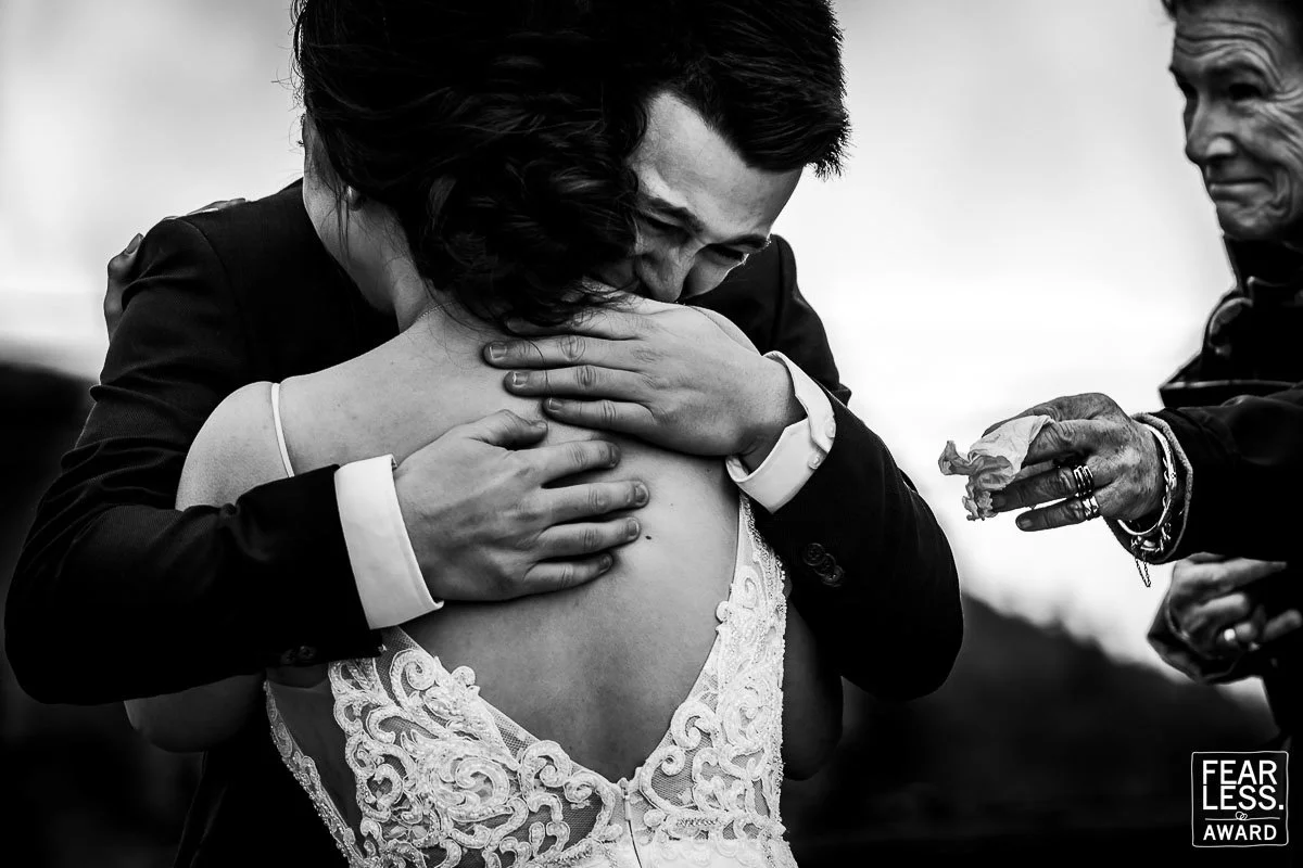emotional wedding hug black and white fearless award candid wedding photography moment