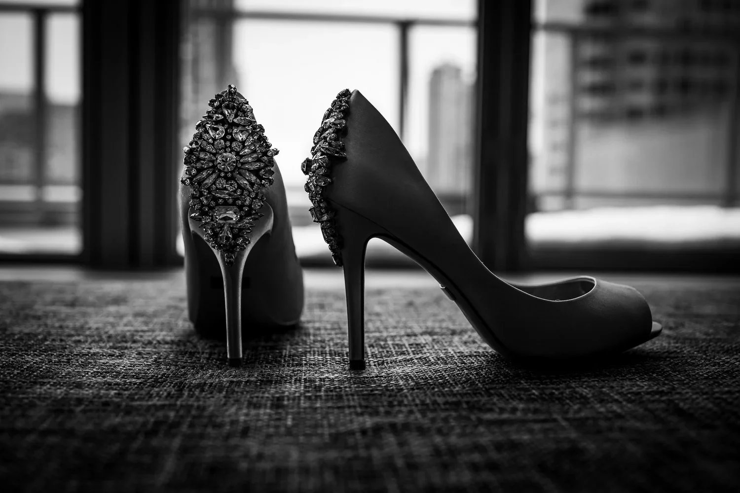 Black wedding heels with crystal detailing photographed in natural light, elegant bridal shoes for wedding day