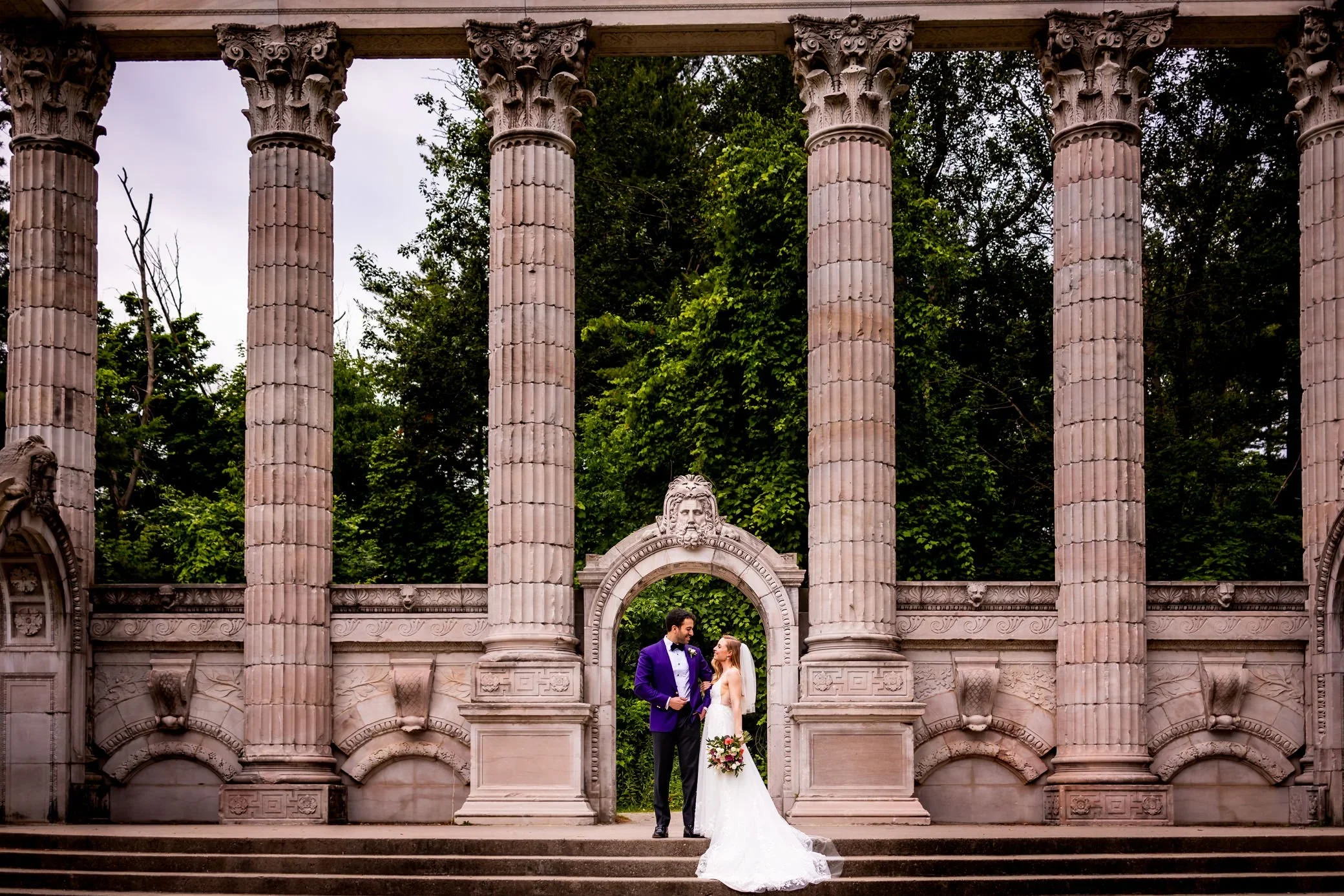 Bride and groom posing under the iconic Guild Inn Estate columns and arches in Scarborough Toronto, classic Guild Inn wedding photo location.