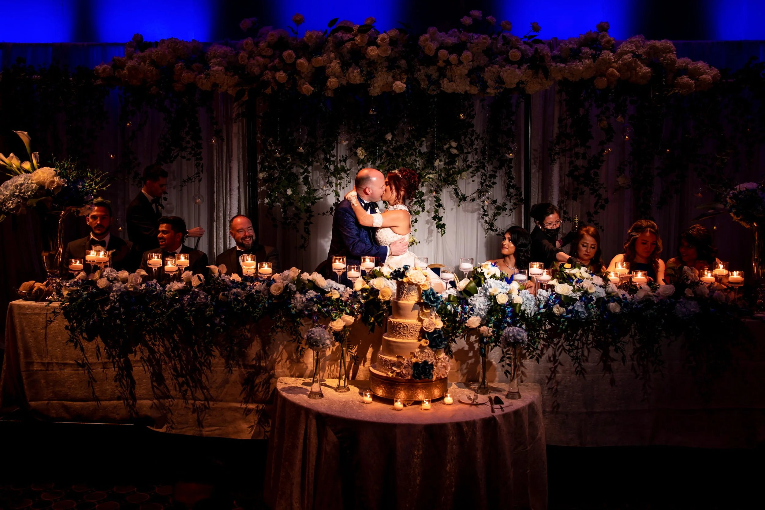 Bride and groom kissing at their reception table during a wedding at The Eglinton Grand in Toronto