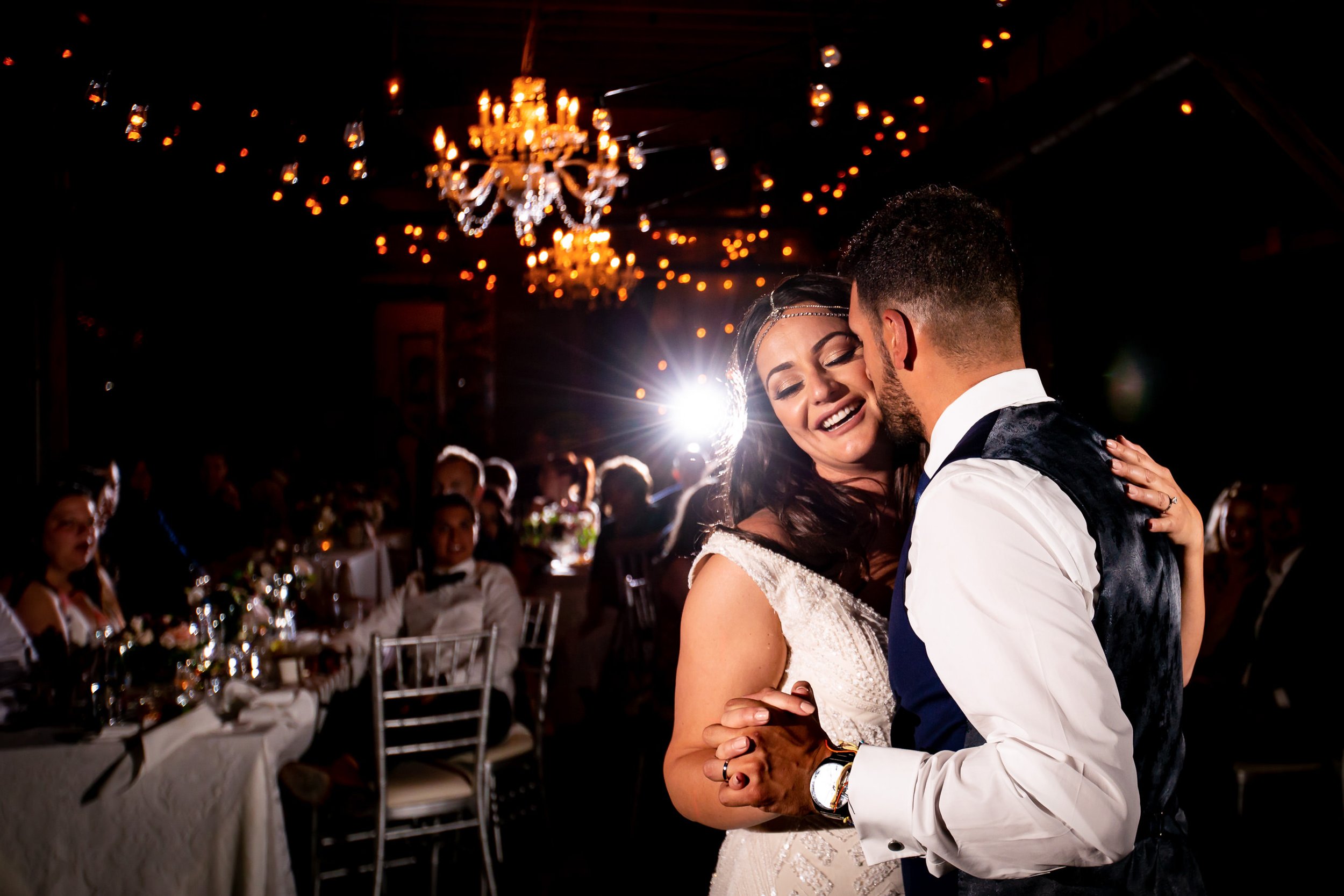 Bride and groom sharing their first dance at The Loft in the Distillery District, with warm lights and guests watching around them