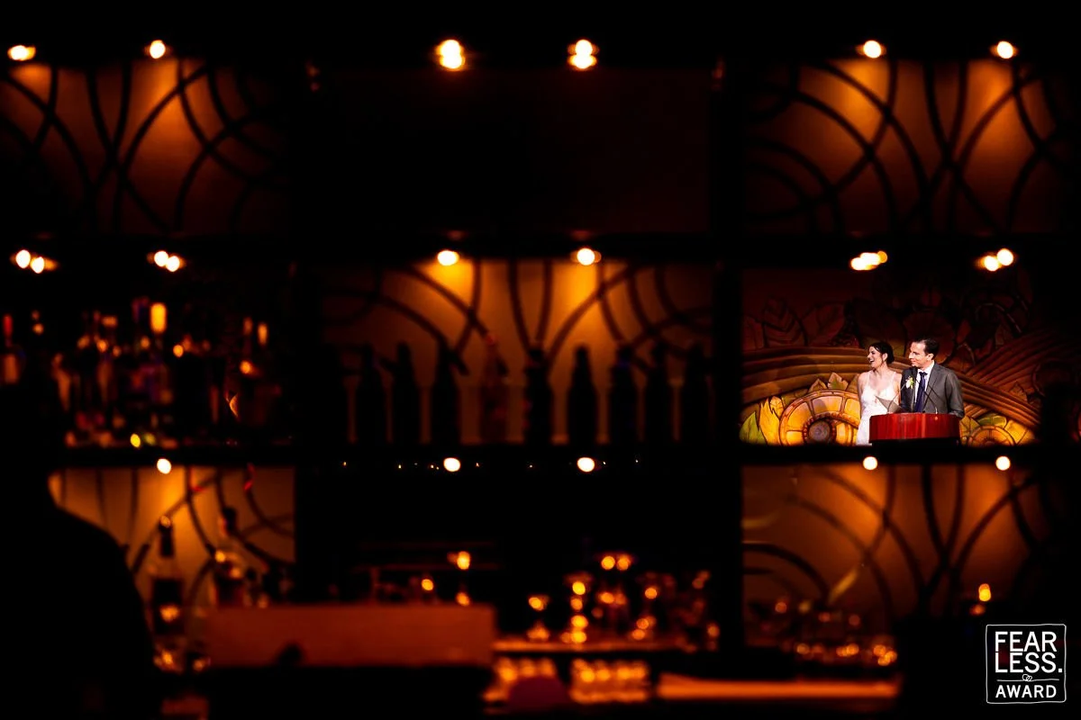 creative wedding speech photo framed through bar fearless award candid storytelling moment