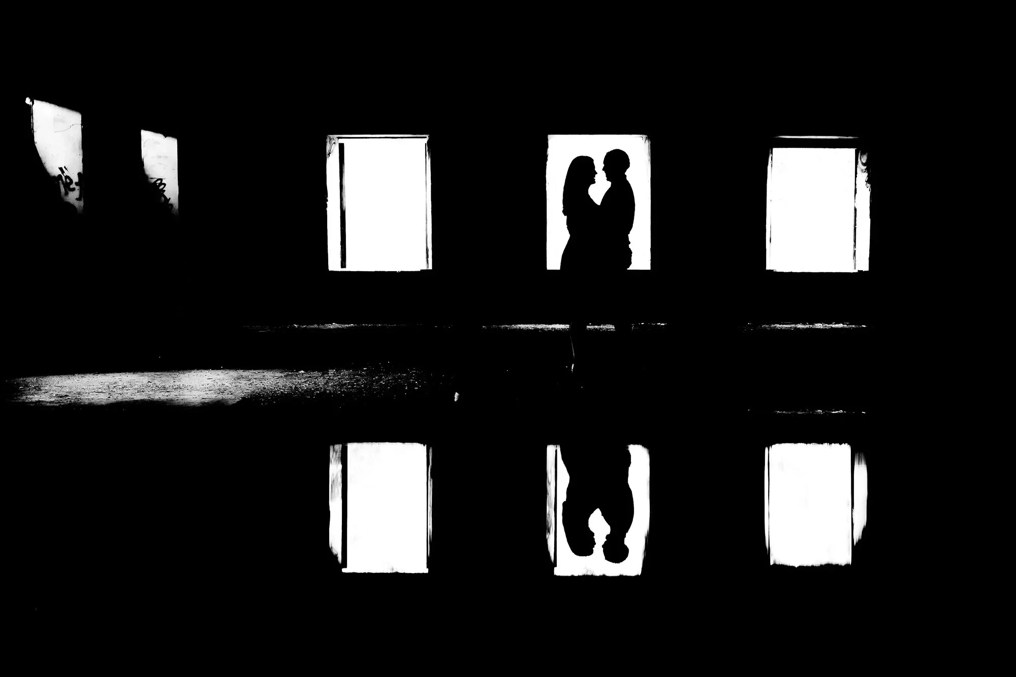 silhouette couple at abandoned Barber Paper Mill engagement session in Georgetown with window light reflection