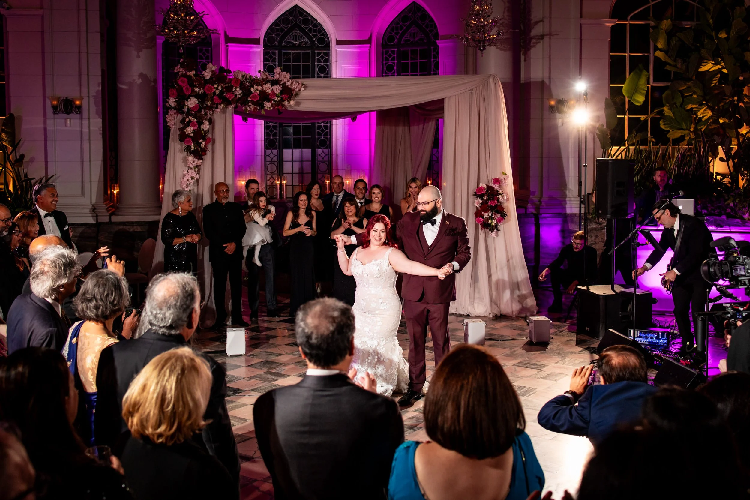Elegant Casa Loma wedding reception in Toronto with couple dancing under purple lighting, emotional and candid wedding photography moment