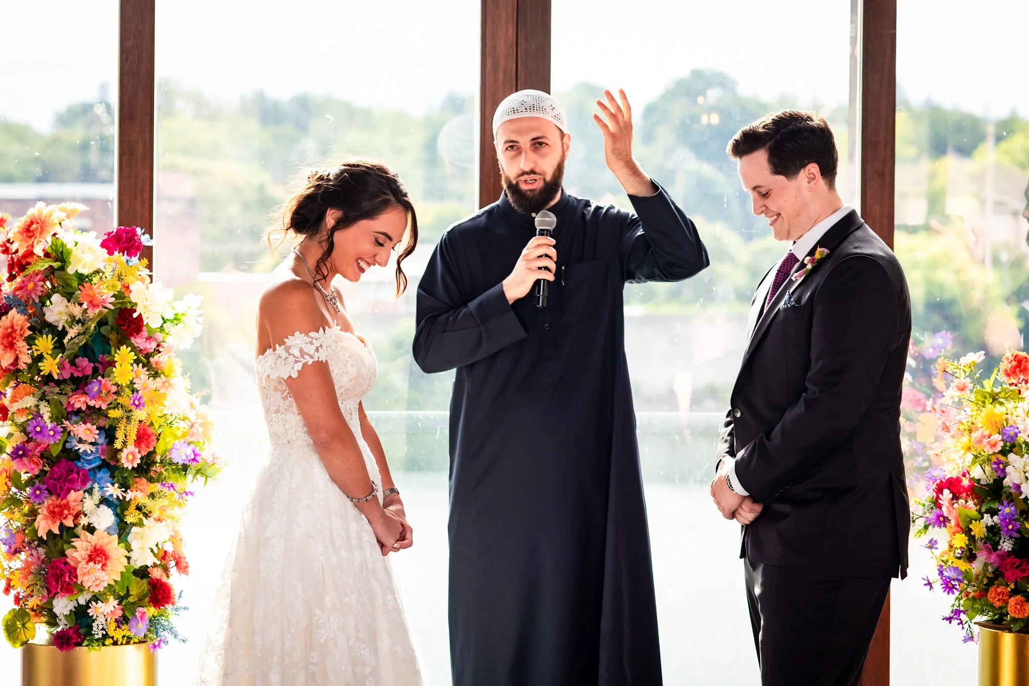 Wedding ceremony at Cambridge Mill with colourful flowers and natural light, photographed by a Toronto wedding photographer