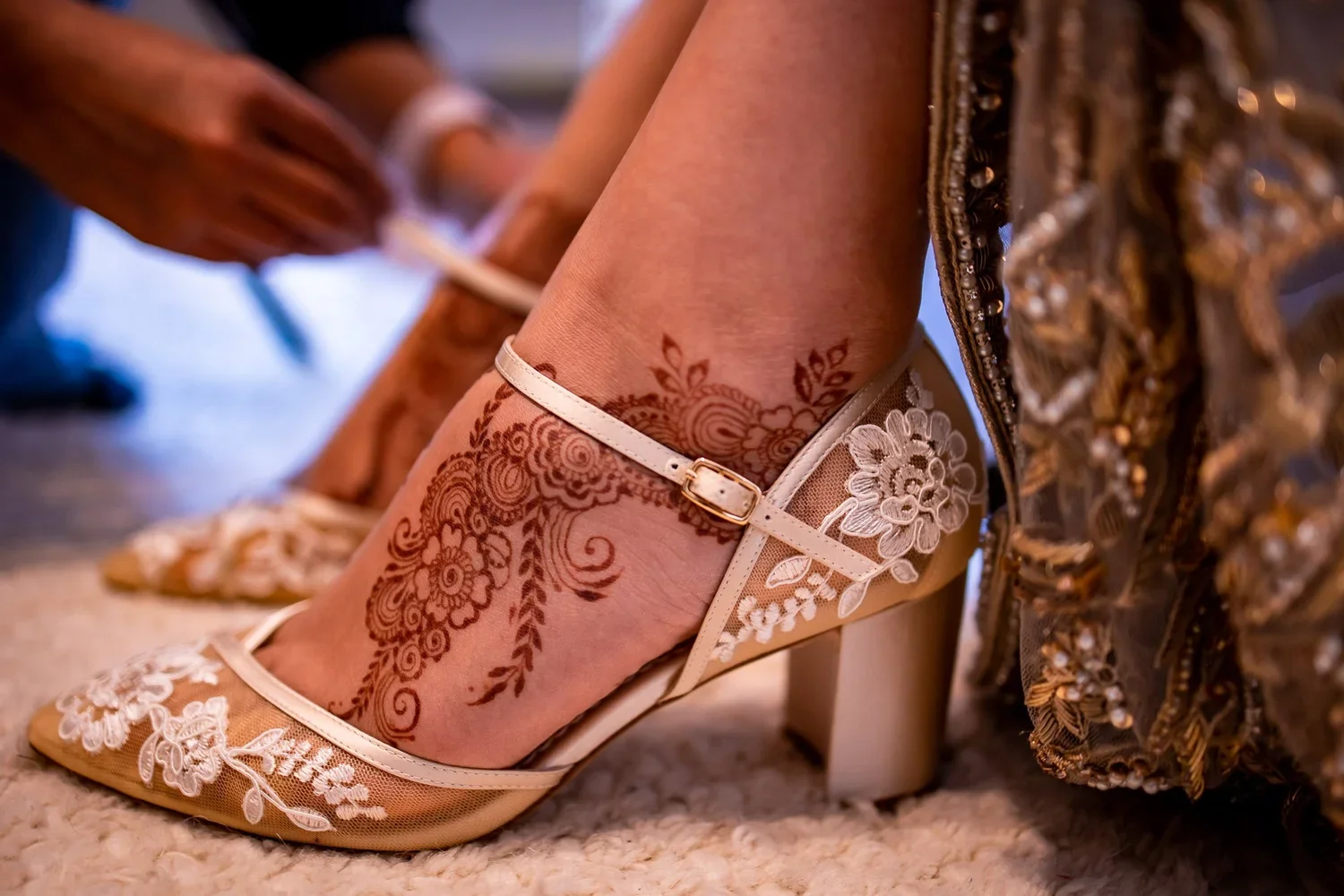 Bridal shoes with henna detail on foot, cultural wedding footwear with embroidered heels and ankle strap