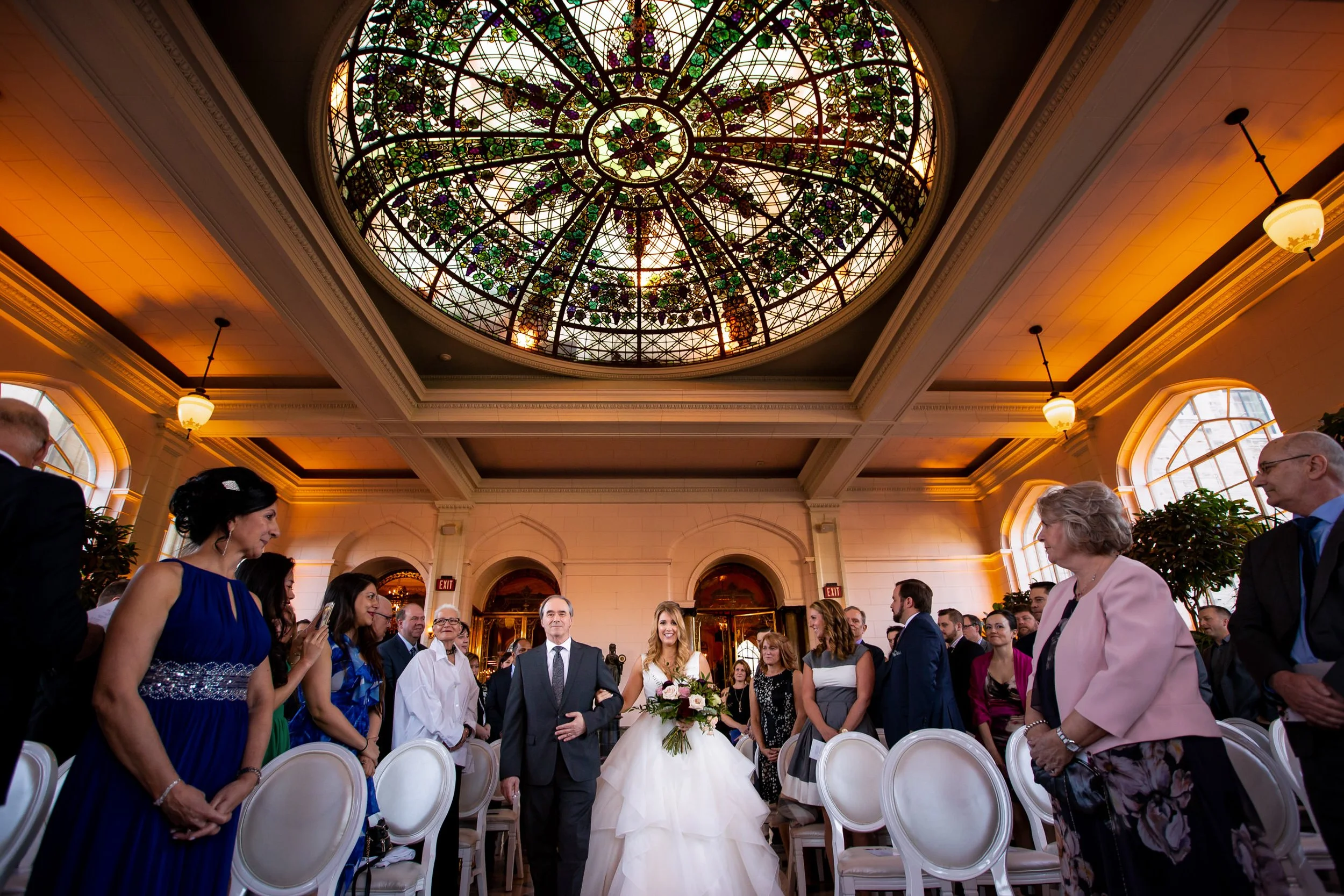 Bride walking down the aisle during a Casa Loma wedding ceremony in Toronto