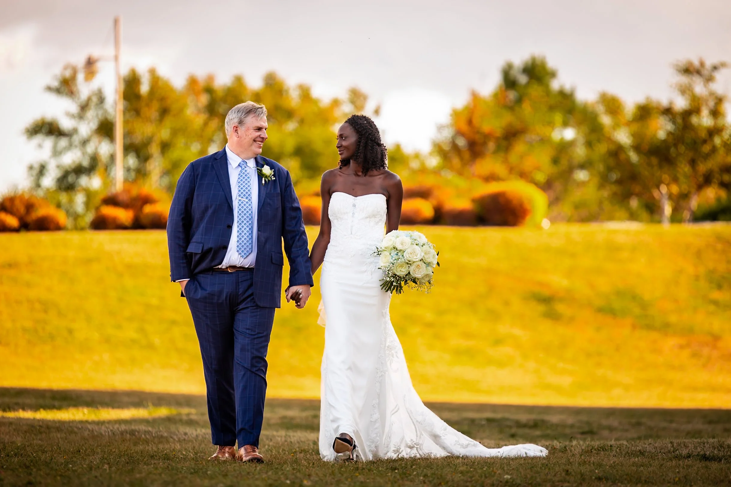 Bride and groom walking hand in hand through the grounds at Rodd Crowbush Golf & Beach Resort during their PEI wedding portraits.