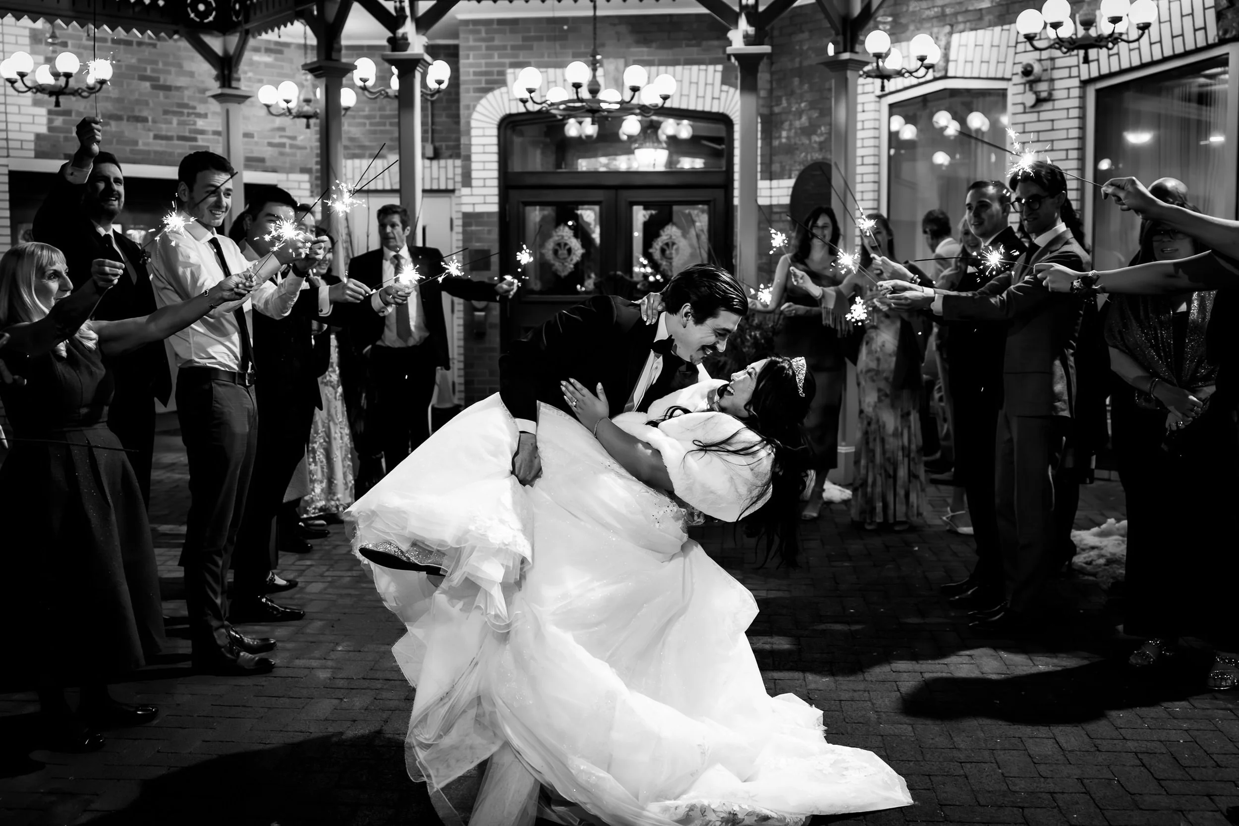 Bride and groom kissing during their sparkler exit outside Prince of Wales Hotel after their Niagara on the Lake wedding