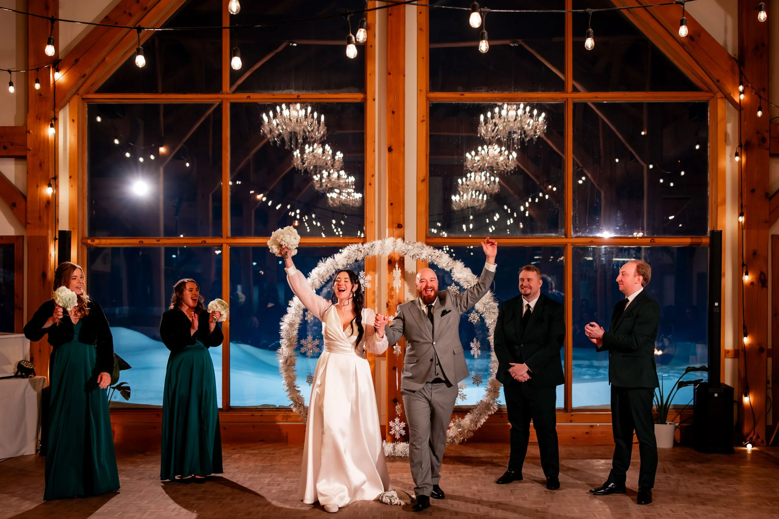Bride and groom entering their wedding reception at Trail Hub in Uxbridge Ontario with warm wood interior and chandeliers