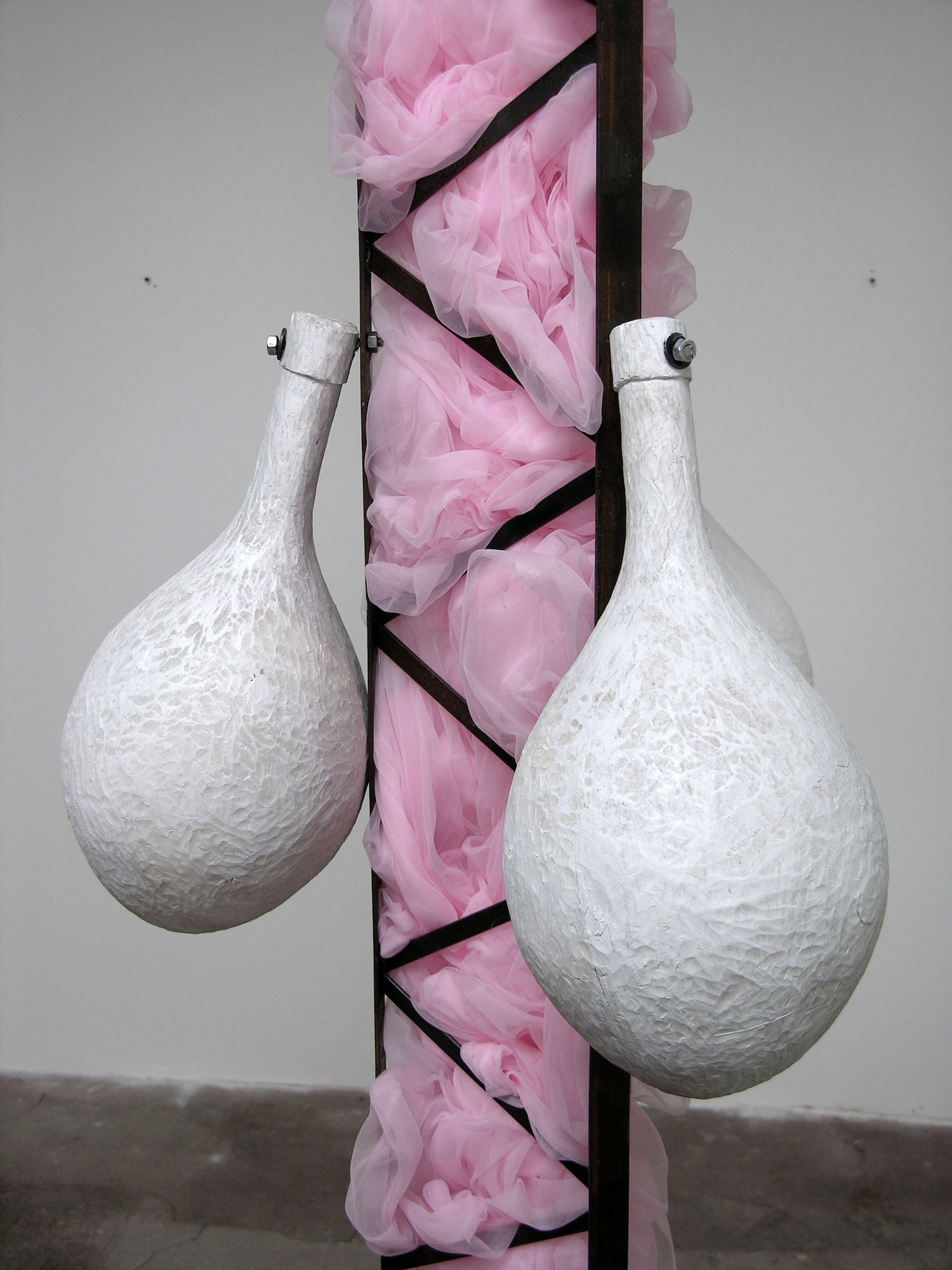  S Machine (2007), detail of the materials in use: pink tutu fabric stuffed into the steel with carved poplar painted white  The show rewards viewing from different angles—close scrutiny of the pieces’ materials and nuances of movement—and a consider