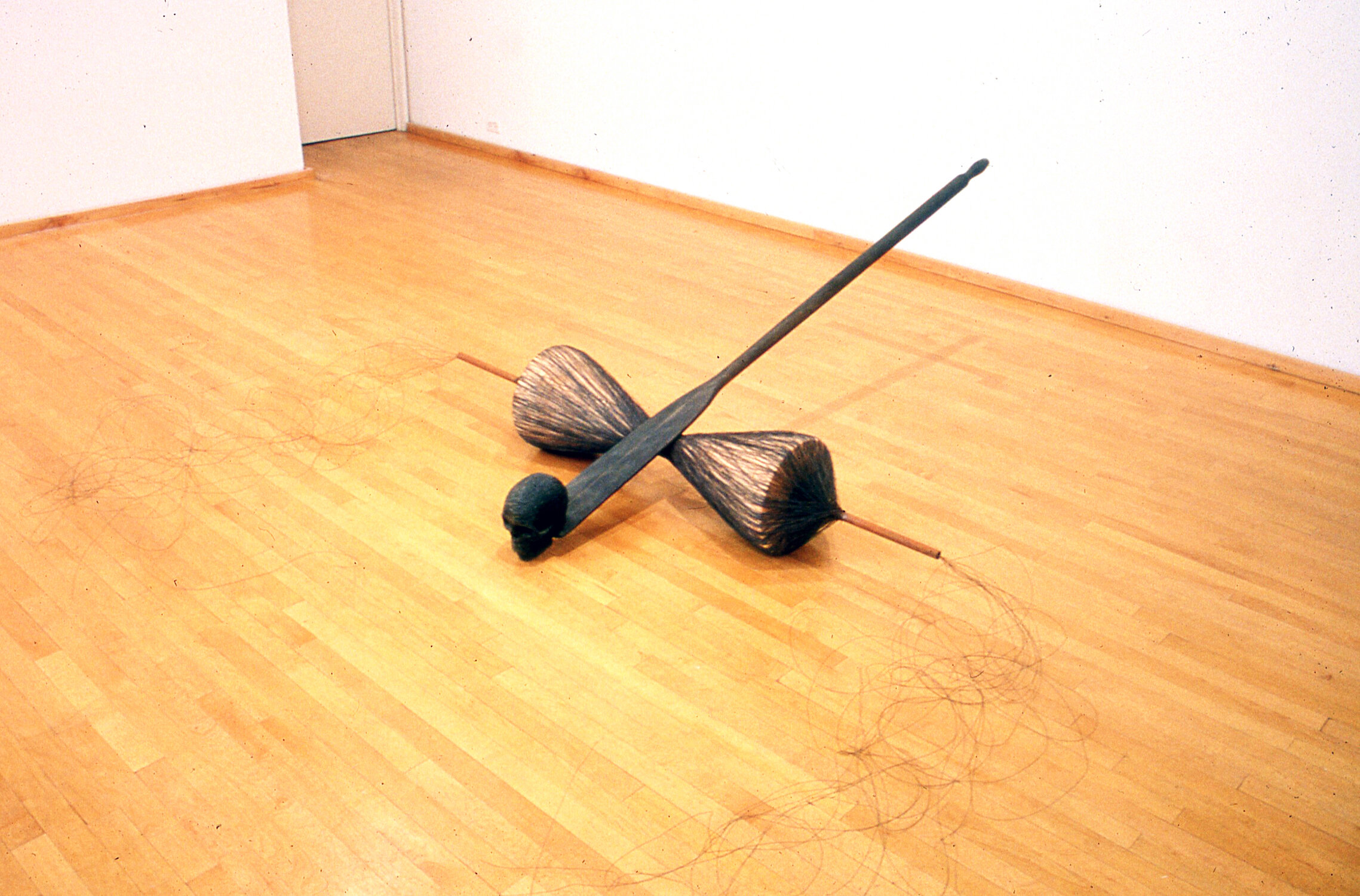  Catapult, 1993, wood, graphite, wire thread, 27 x 81 x 120 inches  Tom Butter’s sculptures of the late ‘70’s and early ‘80’s, eccentric abstractions related to work by John Duff and Eva Hesse, were made of fiberglass. But fiberglass, like abstractio
