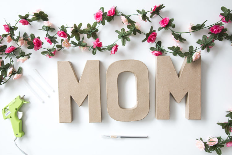 Wall Mural MOM text in big cardboard letters with flowers 