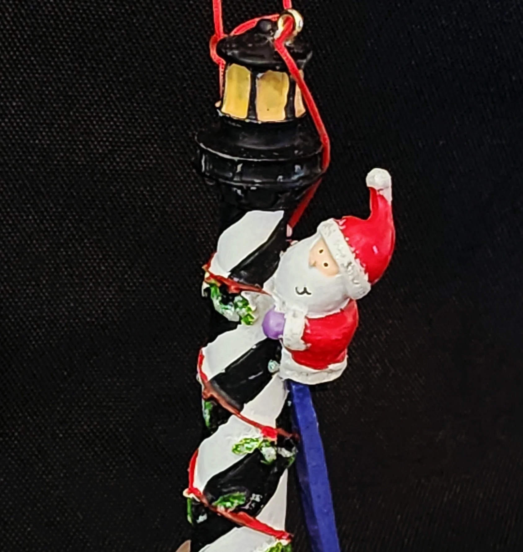 Santa Climbing Lighthouse Ornament