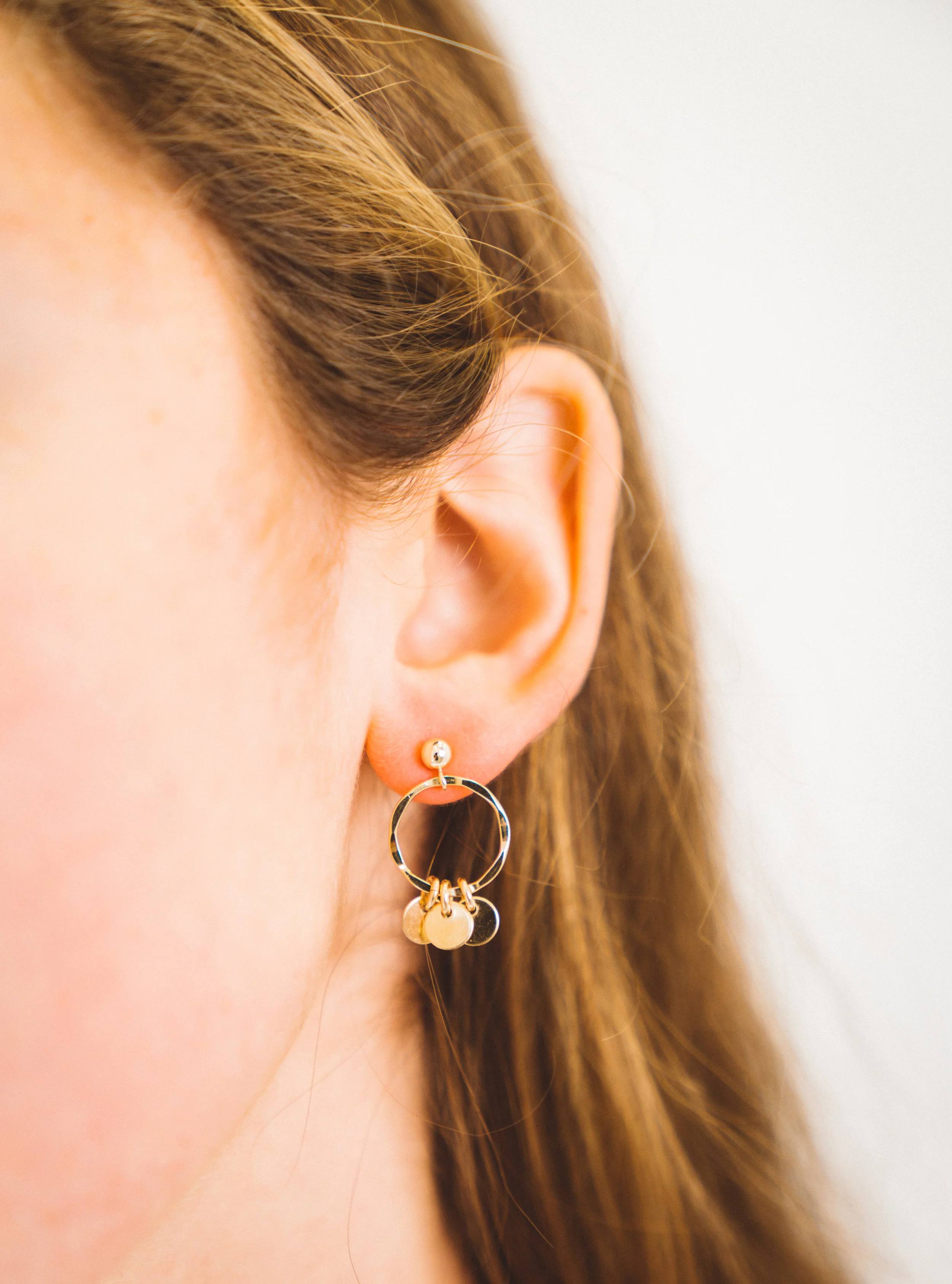Gold earrings accented with golden discs