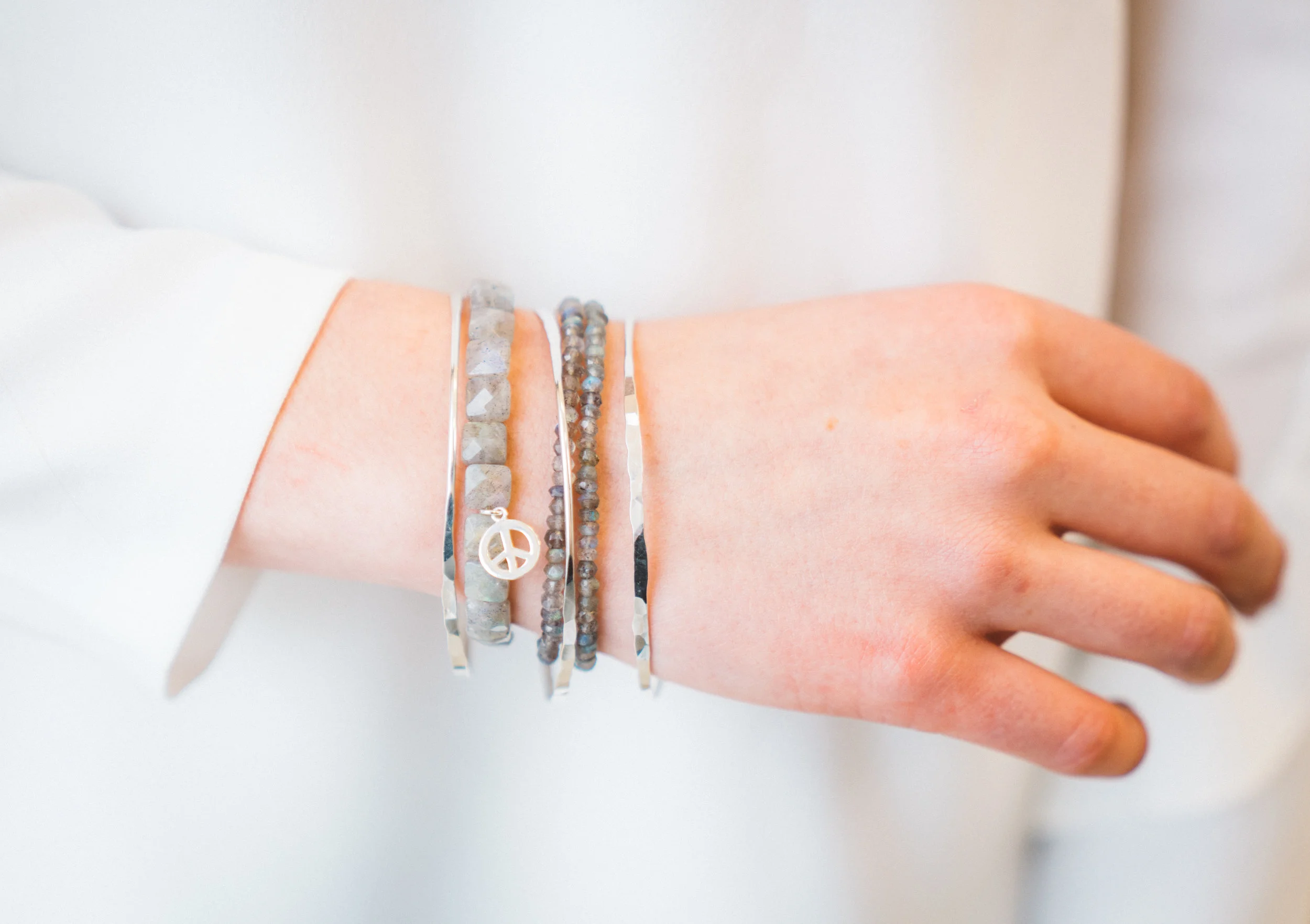 Salt Spring stackable bracelets with cubed labradorite and peace charm