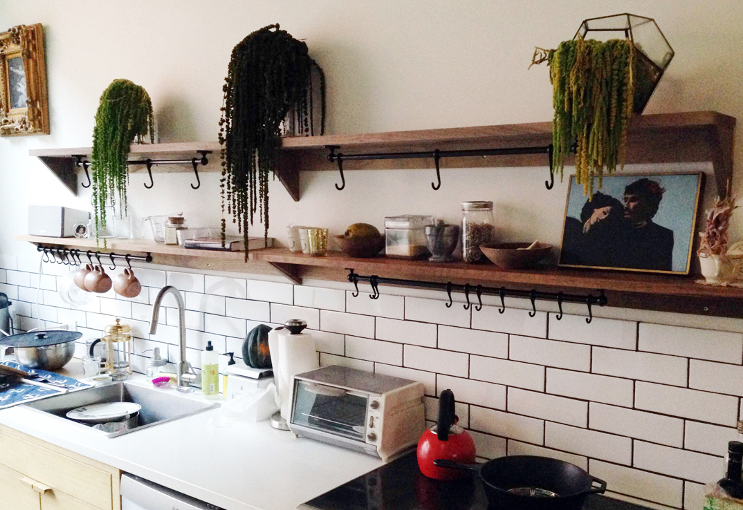 Wood shelves and subway tile backsplash.