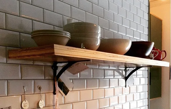 Kitchen with subway tile and microlam shelf.