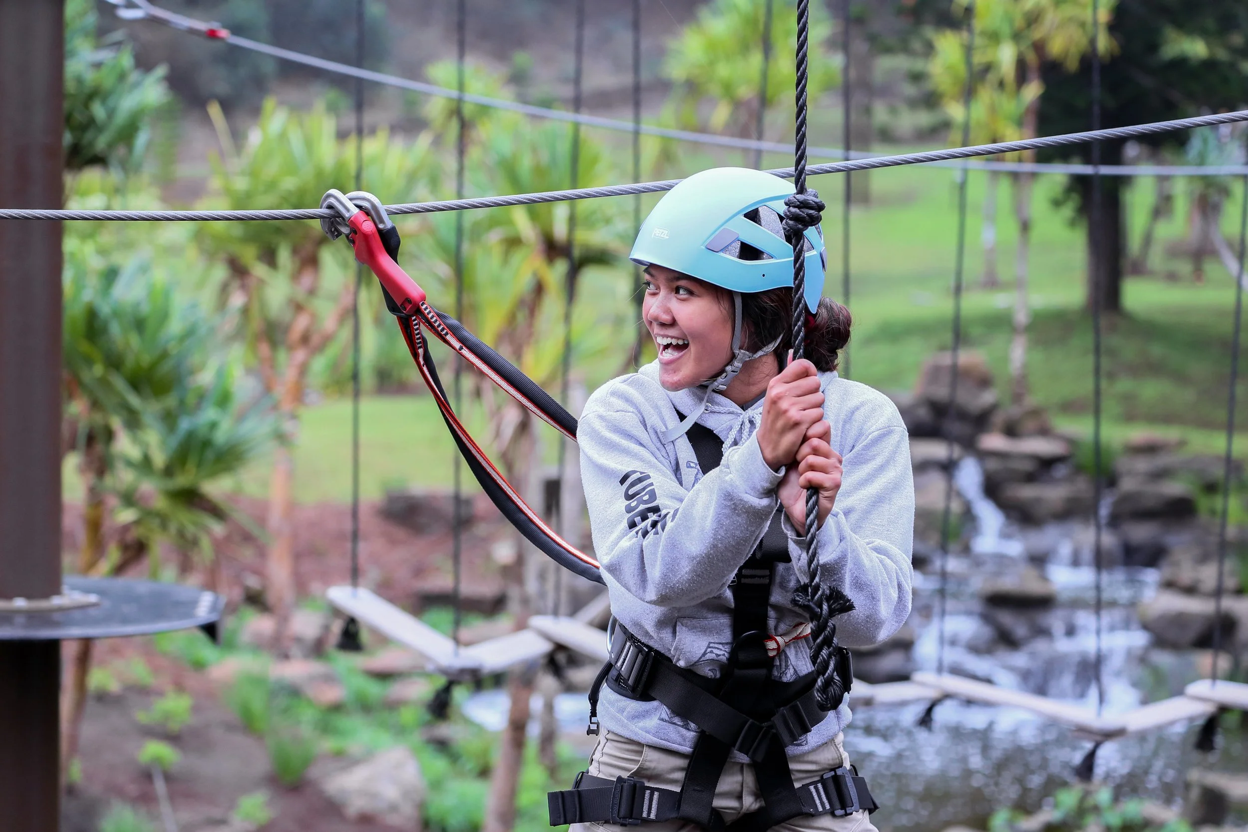 Guest in safety gear enjoying Aerial course