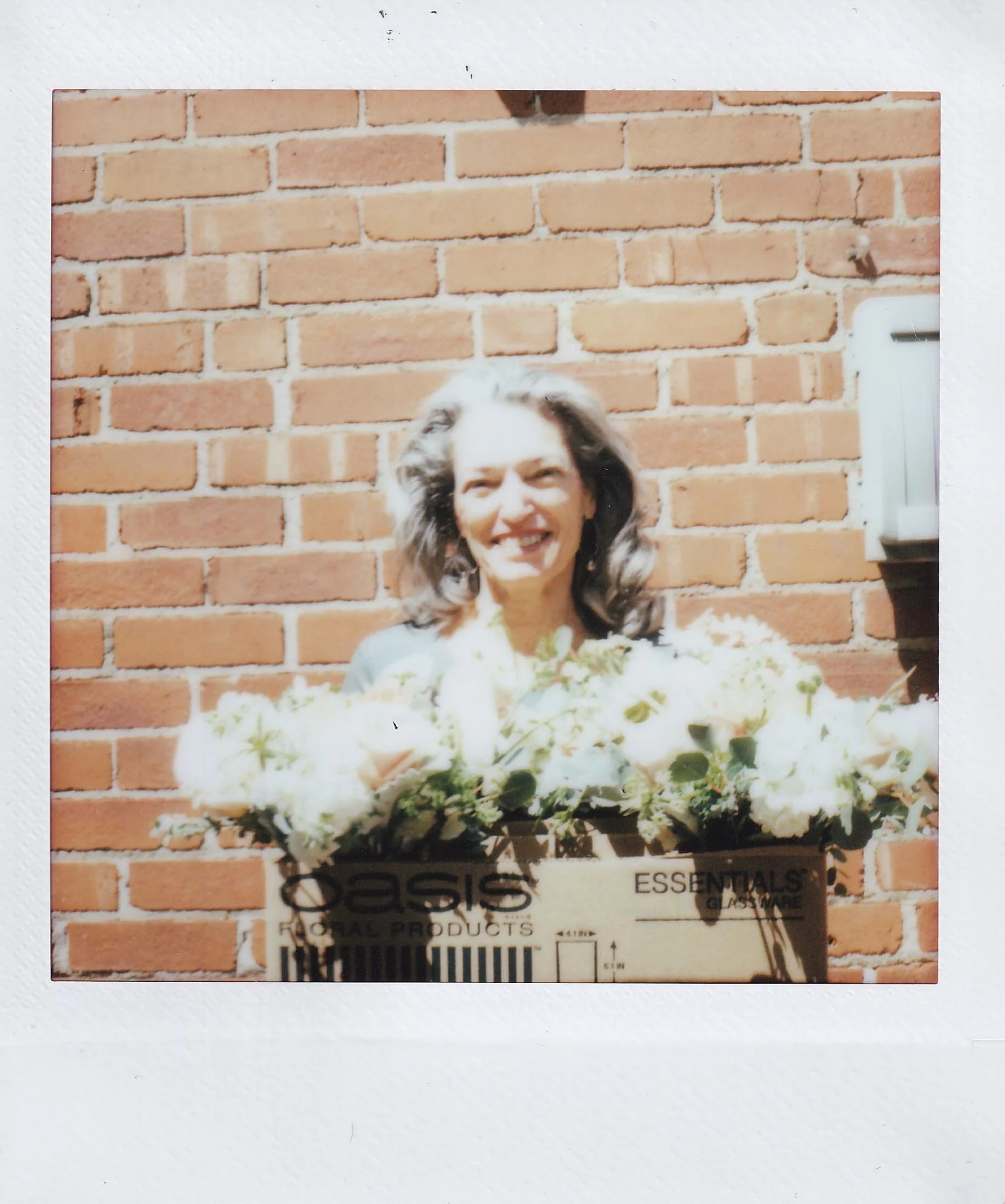 mom holding flowers for kinsey's bridal shower 2, office courtyard, friday, 5-5-23.jpg
