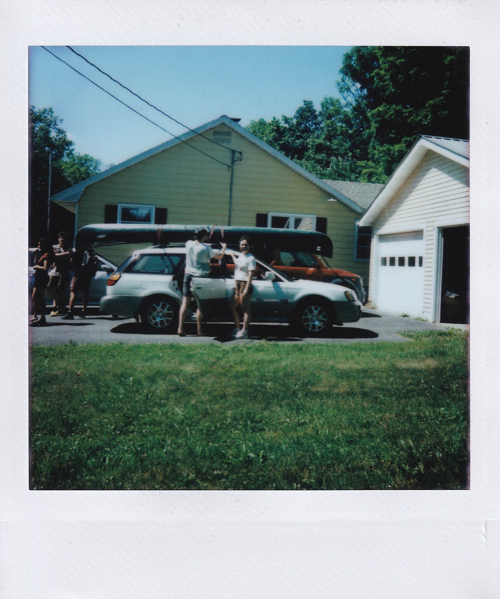 nick and anna putting the canoe on the car to camp at saranac lake, at dan and kendra's in woodstock new york, friday, 7-4-25.jpg
