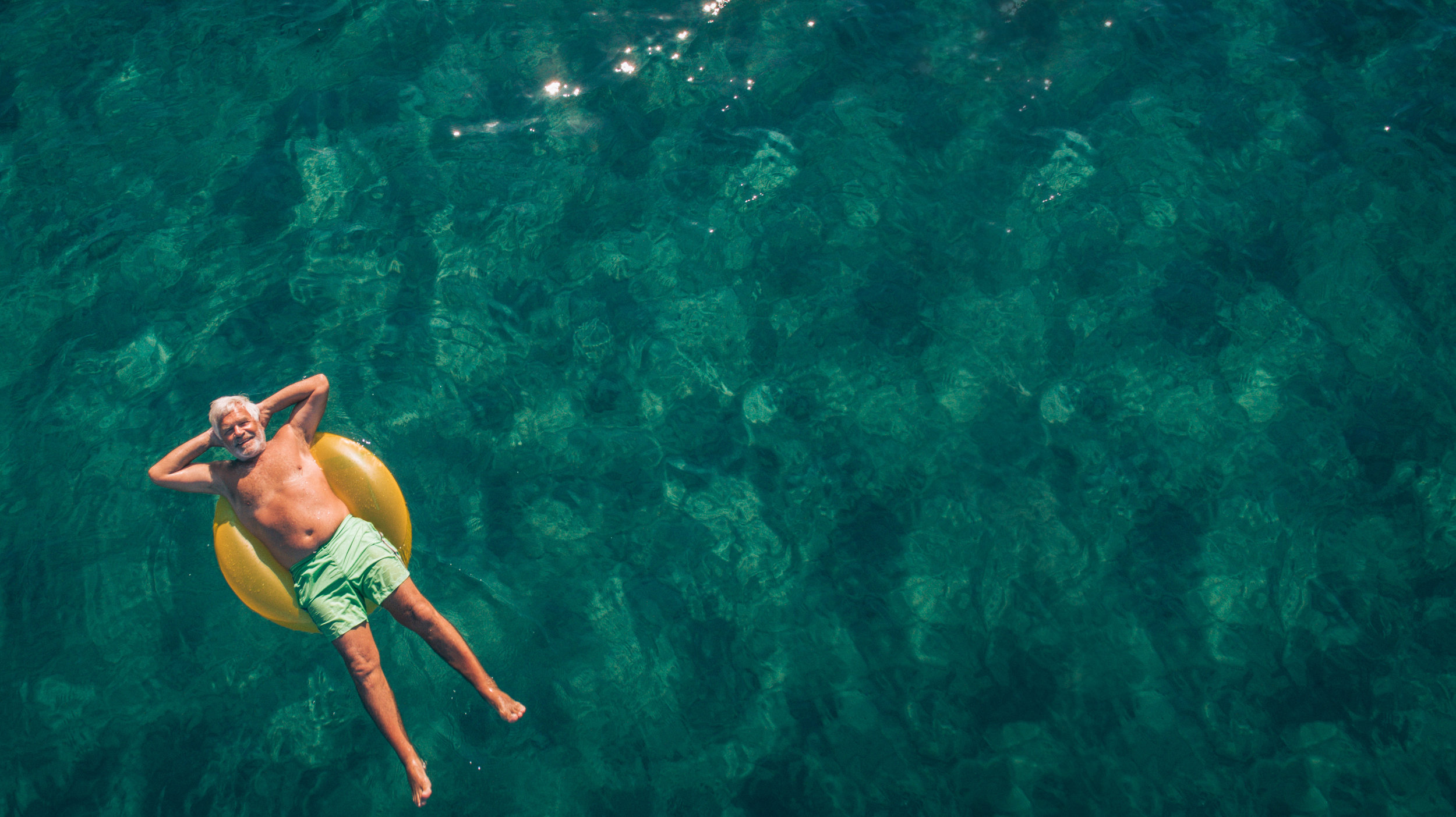 Man relaxing in the sea in an intertube.jpg
