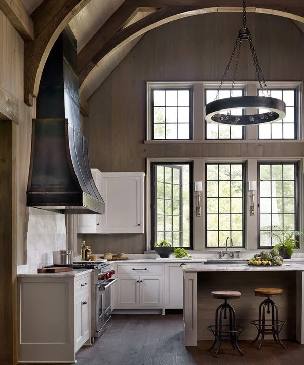 A large kitchen window design idea with a vaulted ceiling and planked walls. Source: Jeffrey Dungan Architects