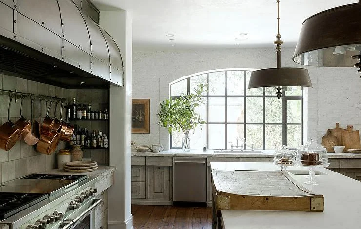A striking black industrial window is set flush with the countertop and can help a large kitchen window design idea feel fresh and modern. Source: Eleanor Cummings Design